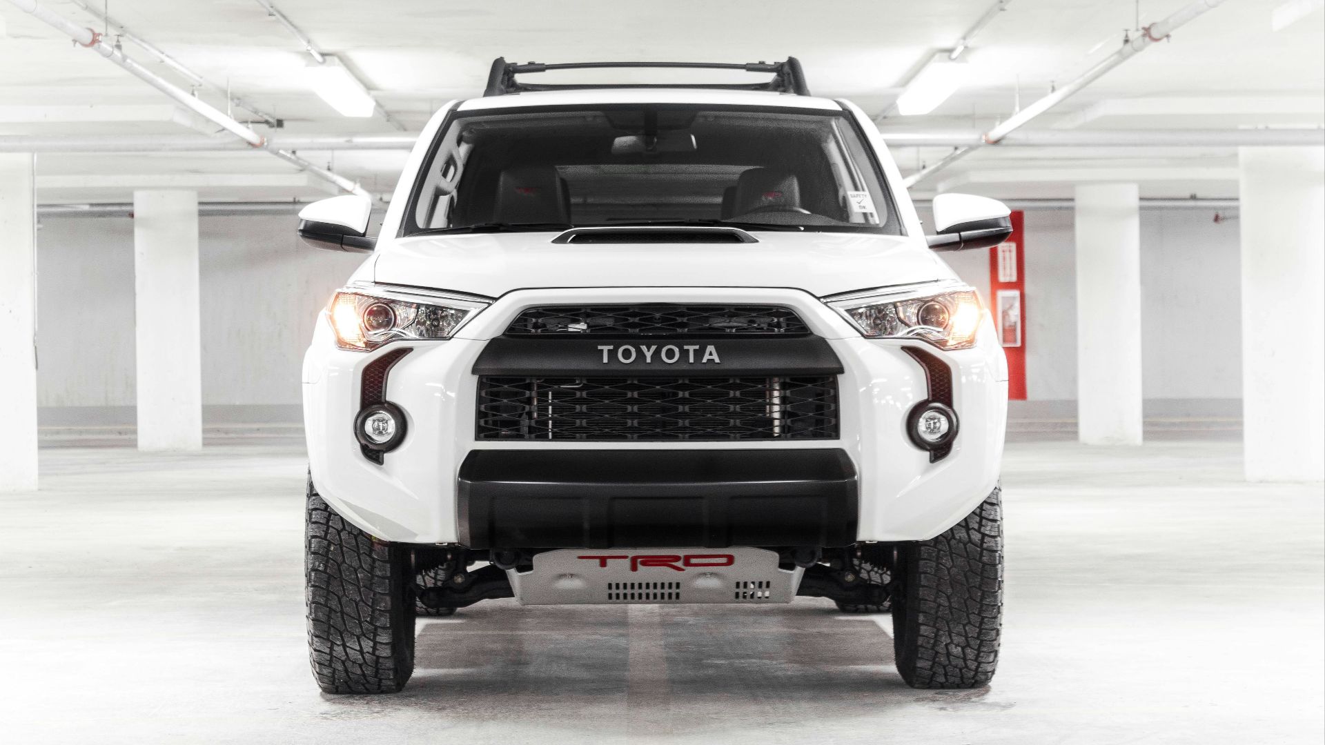 a white truck parked in a parking garage