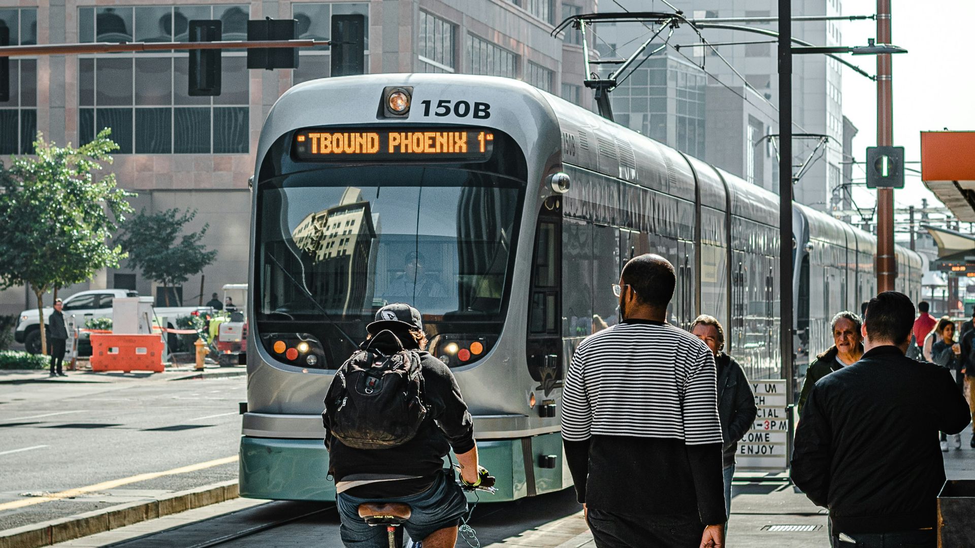 people walking on pedestrian lane near white and red train during daytime