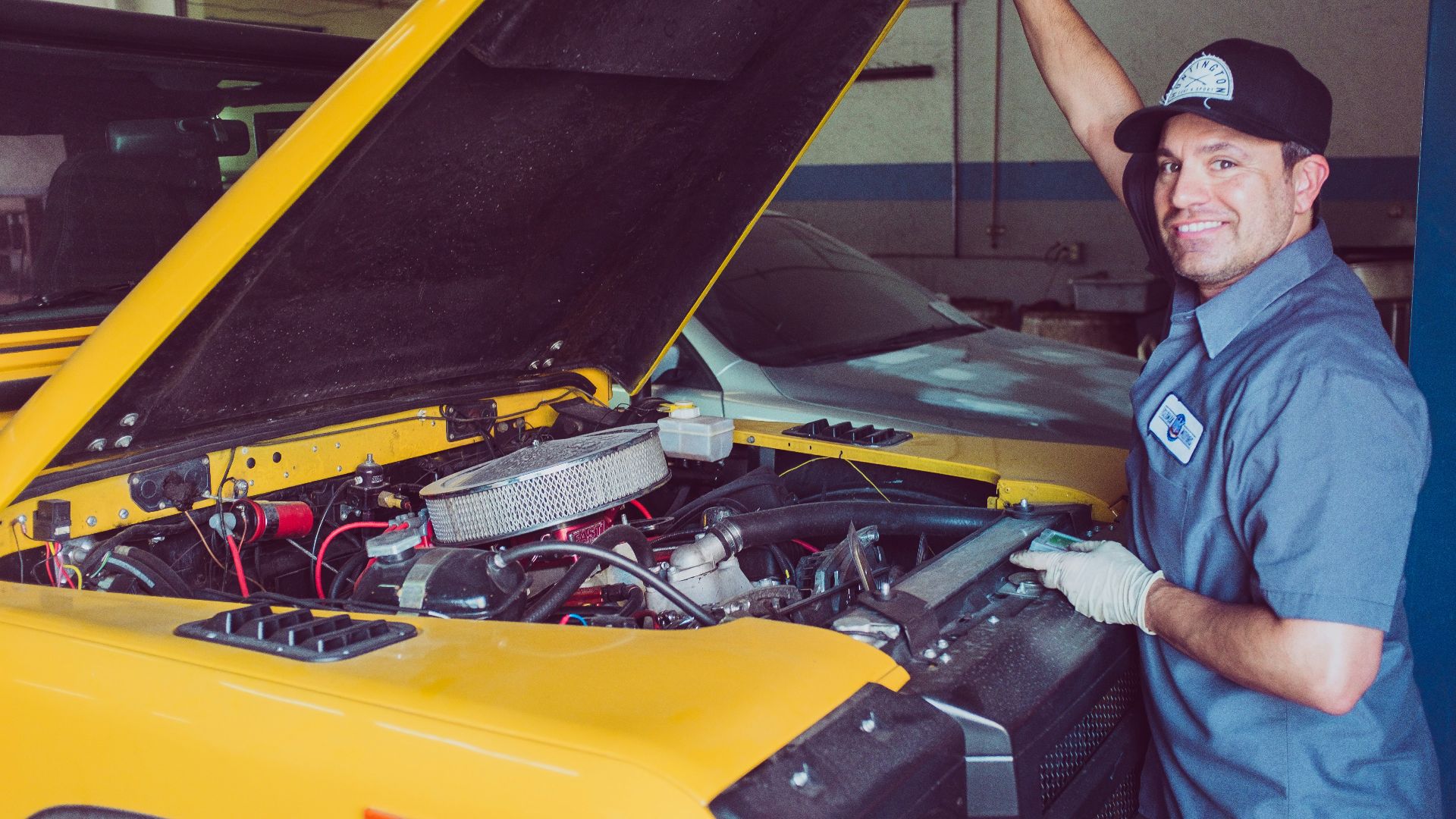 man holding open-wide car trunk
