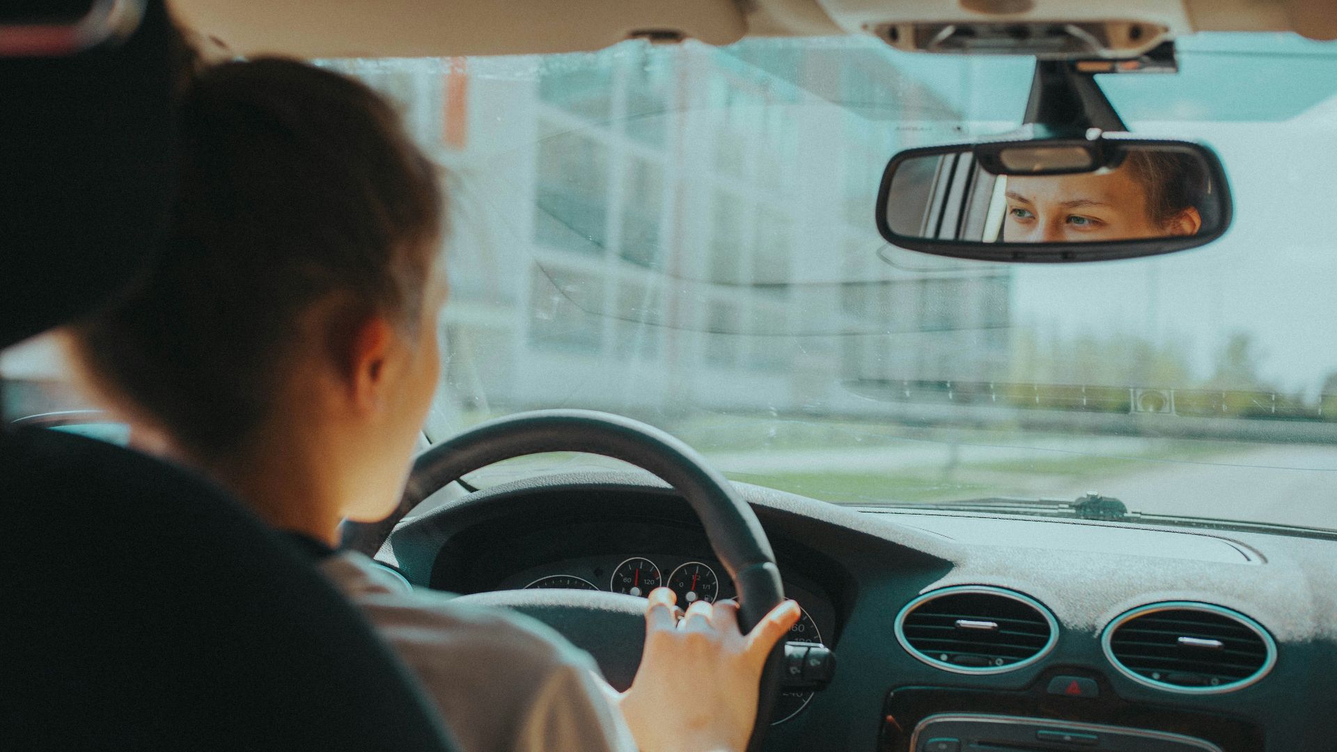 man in black shirt driving car