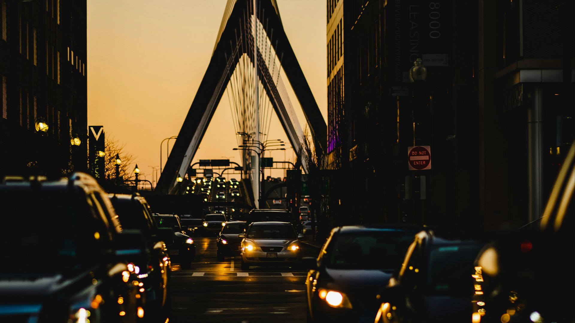 a city street filled with traffic next to tall buildings