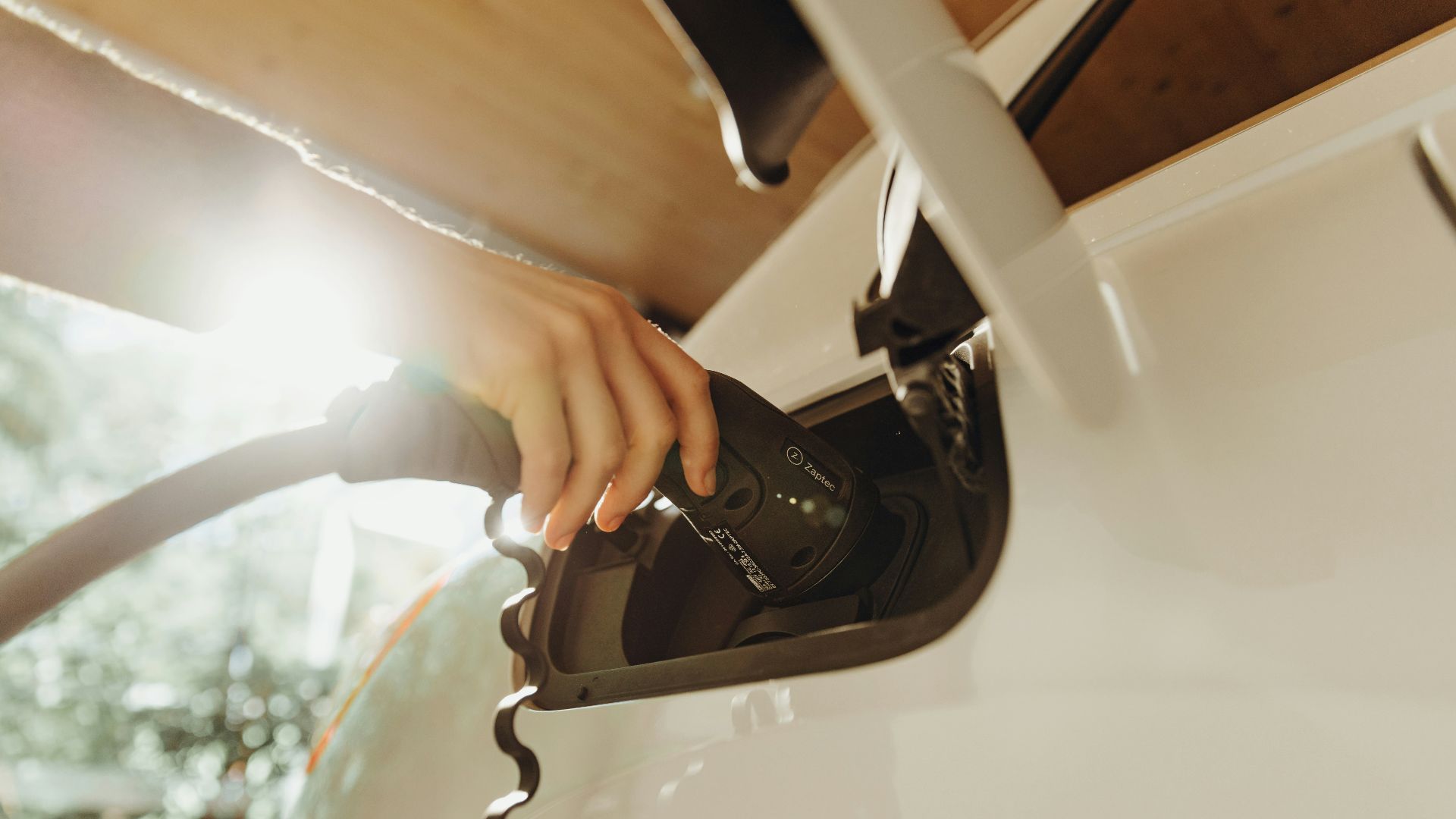 a person pumping gas into a car at a gas station