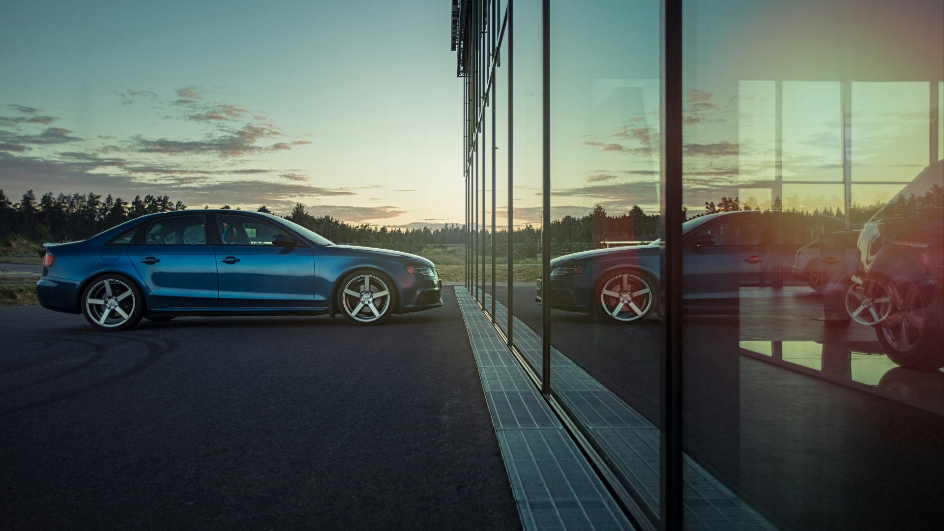 blue sedan on road during daytime