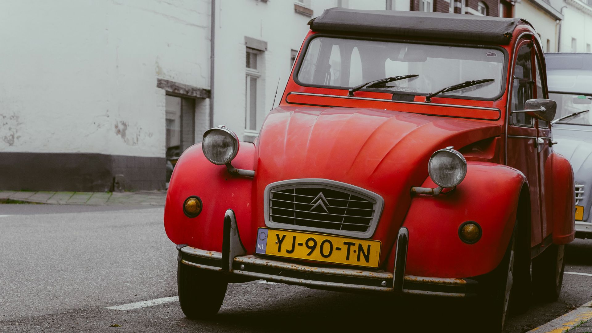 a red car parked on the side of the road