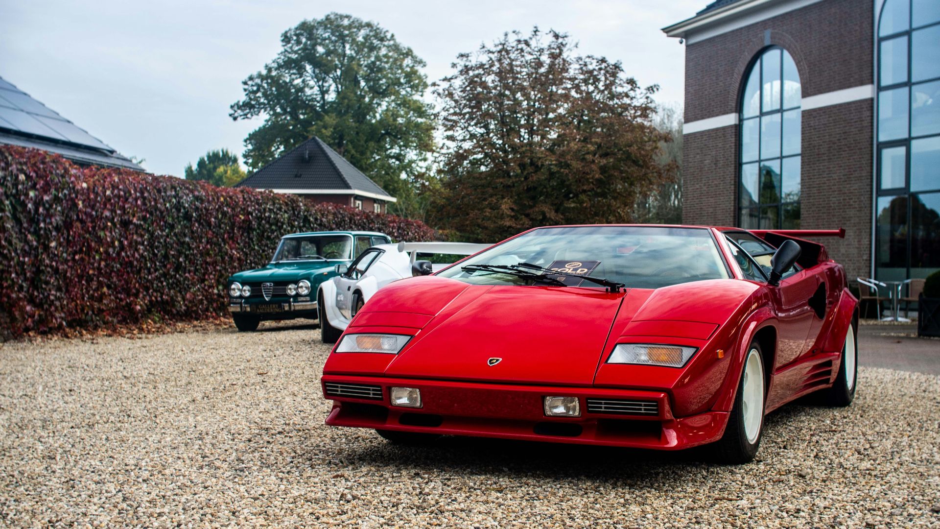 A red sports car parked in front of a building