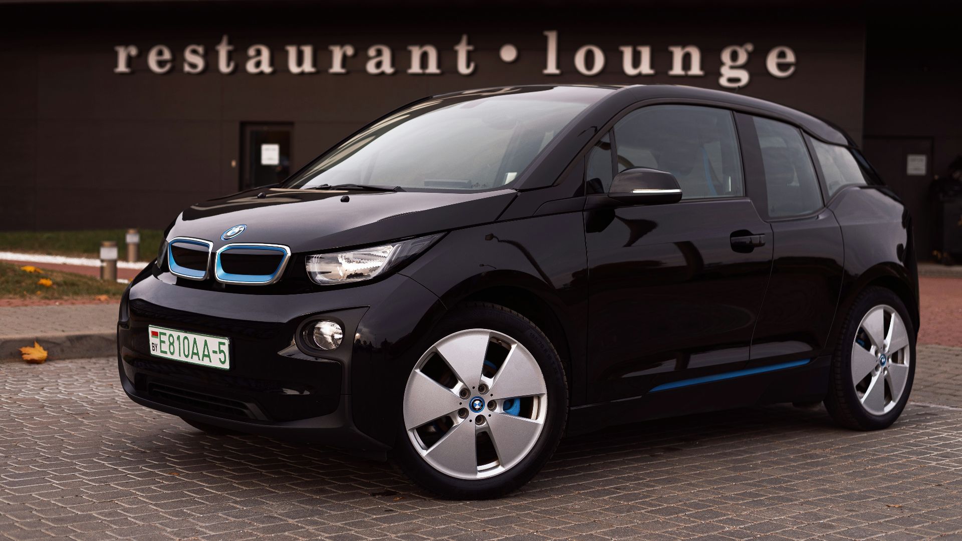 a black car parked outside a building