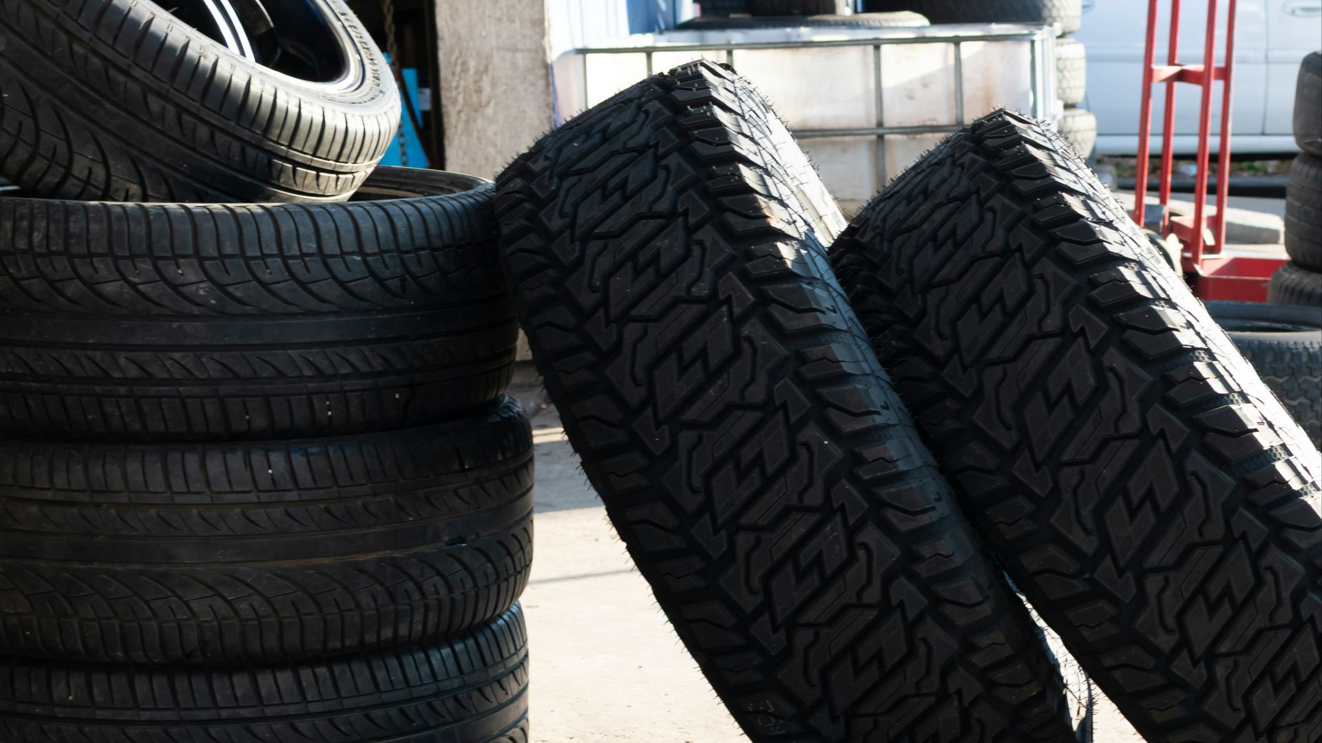 Stack of tires outside a garage