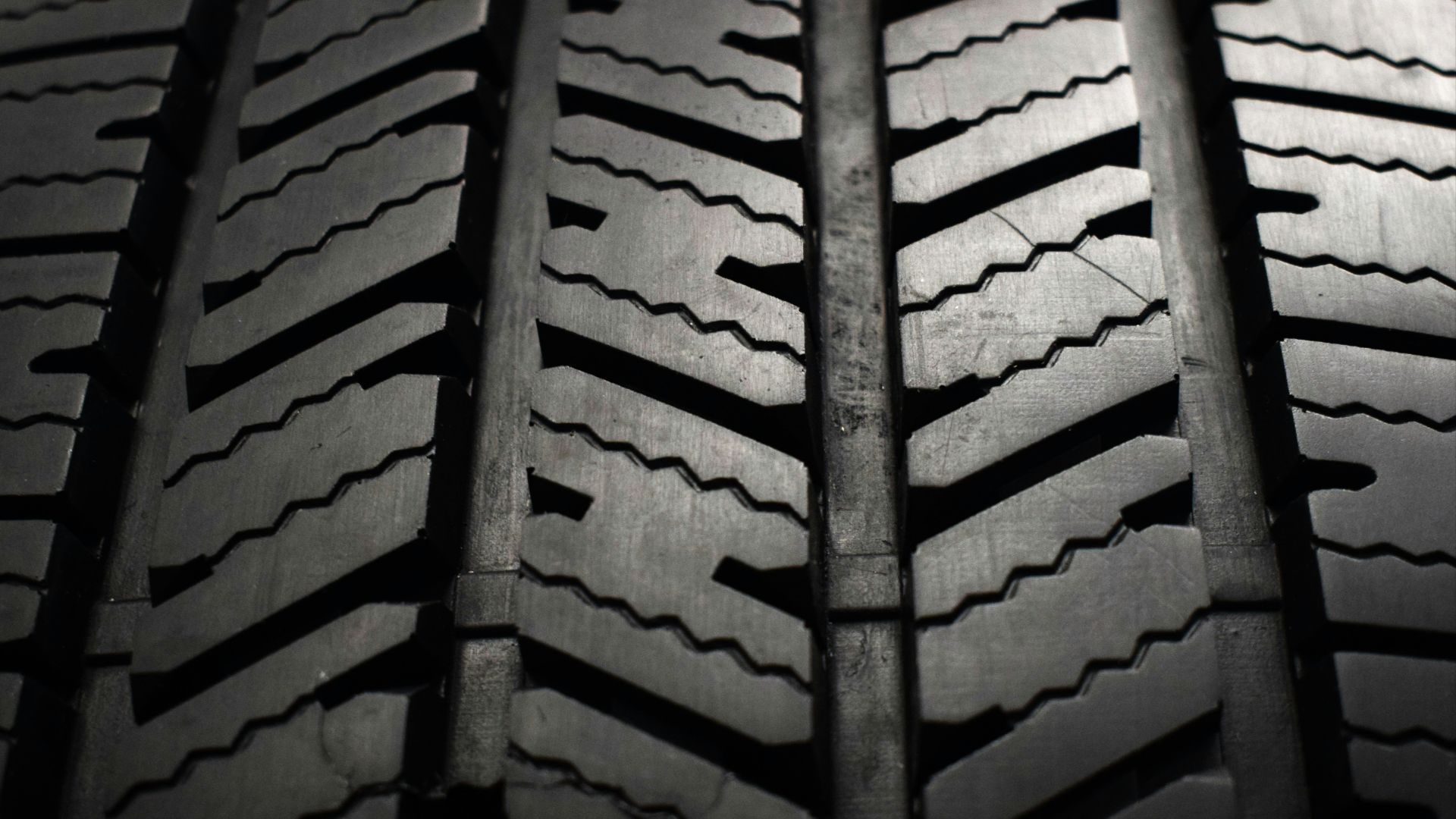 A close up of a tire on a black background