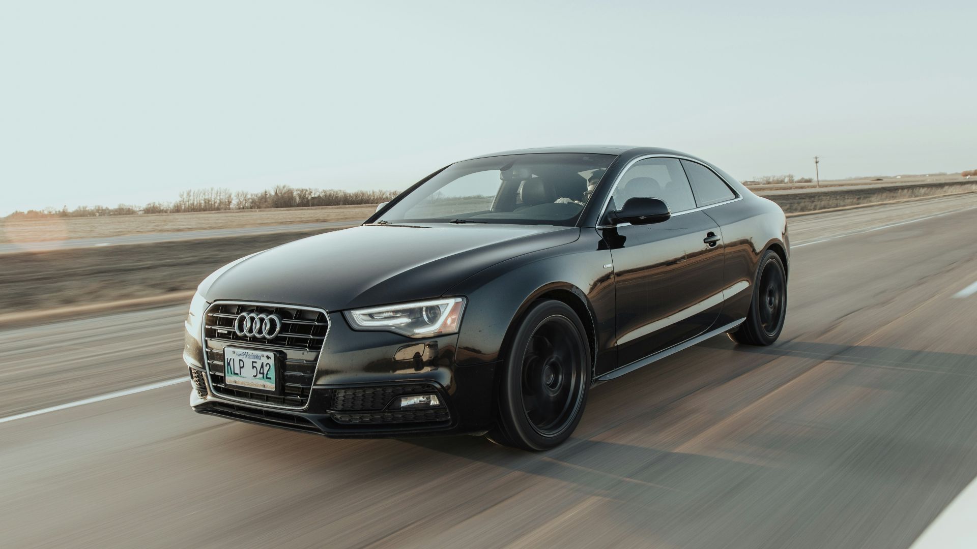 black audi sedan on road during daytime
