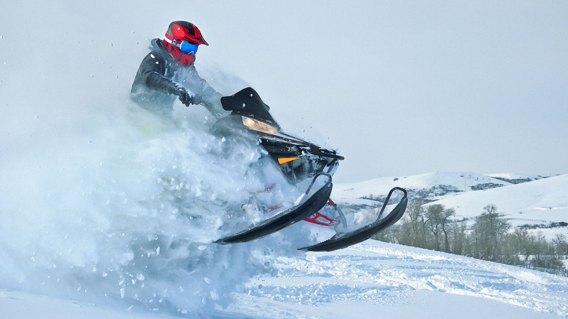 a person riding a snowmobile in the snow