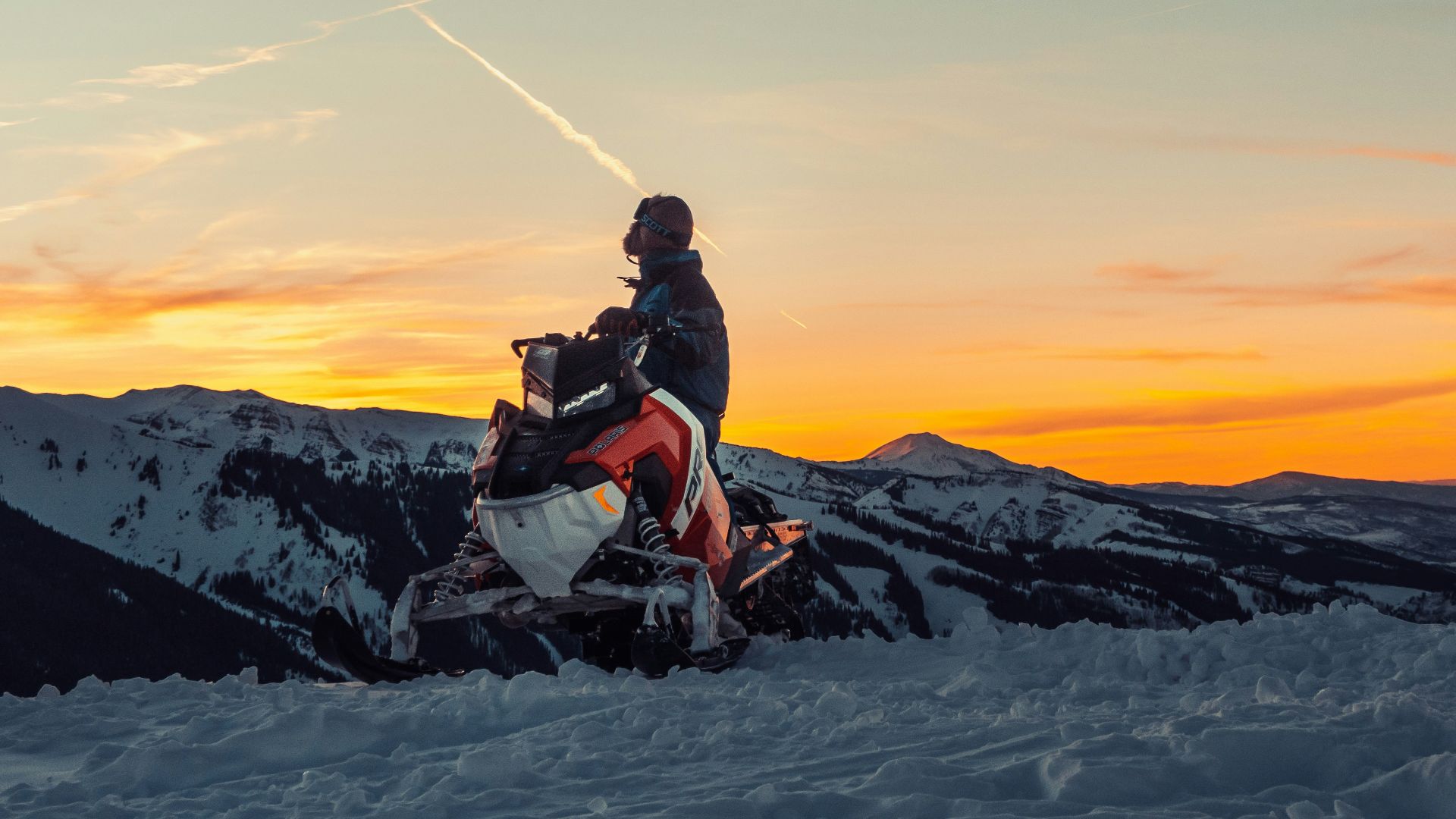 man riding snow mobile