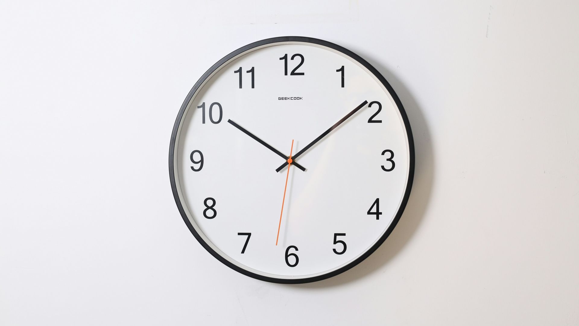 round analog wall clock pointing at 10:09