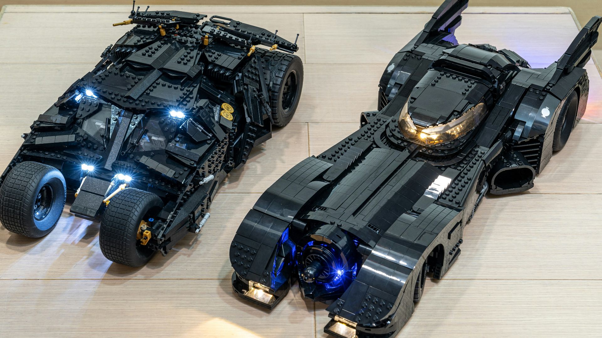 two lego batman cars are on a table