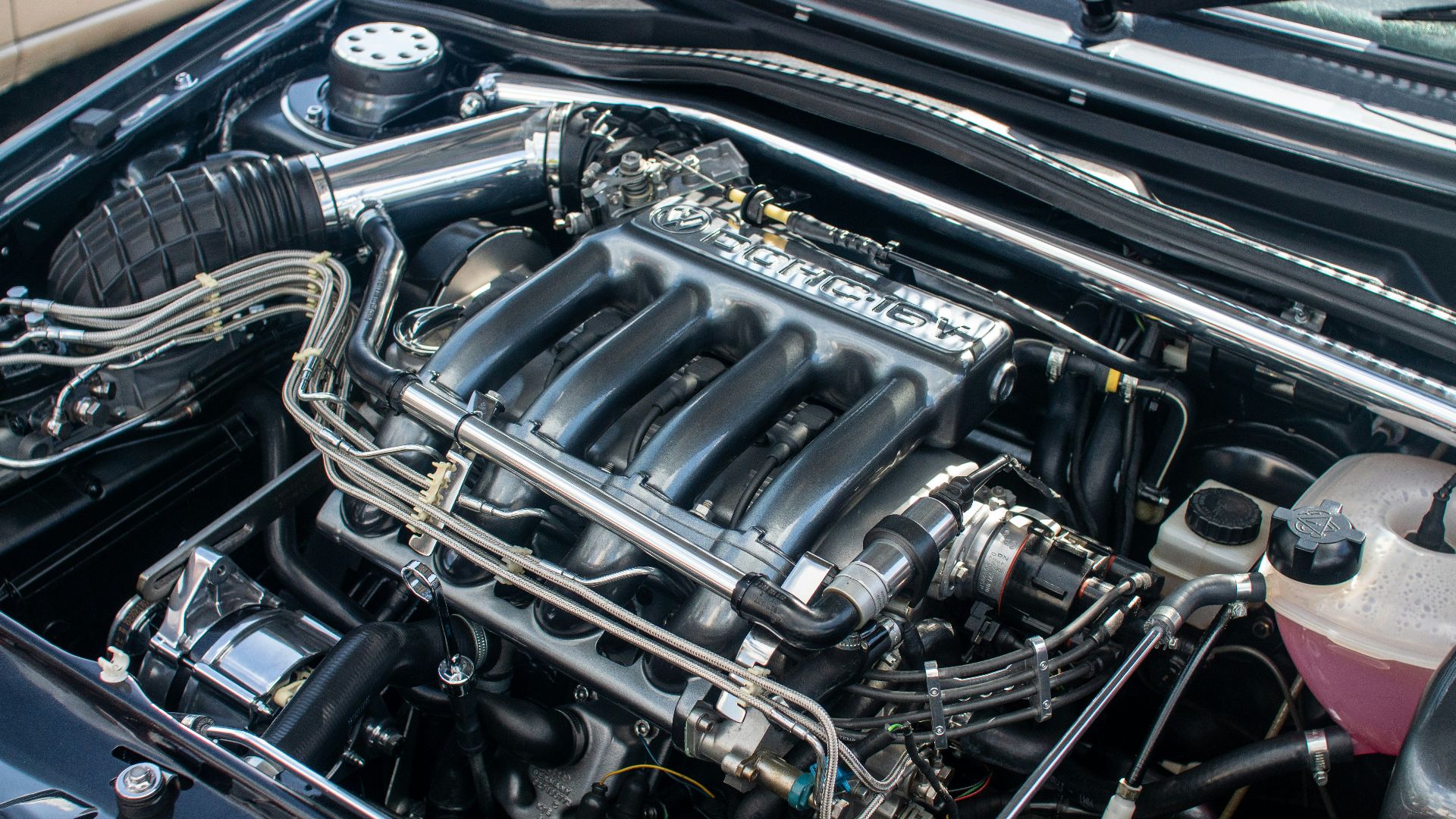 The engine compartment of a car with the hood up