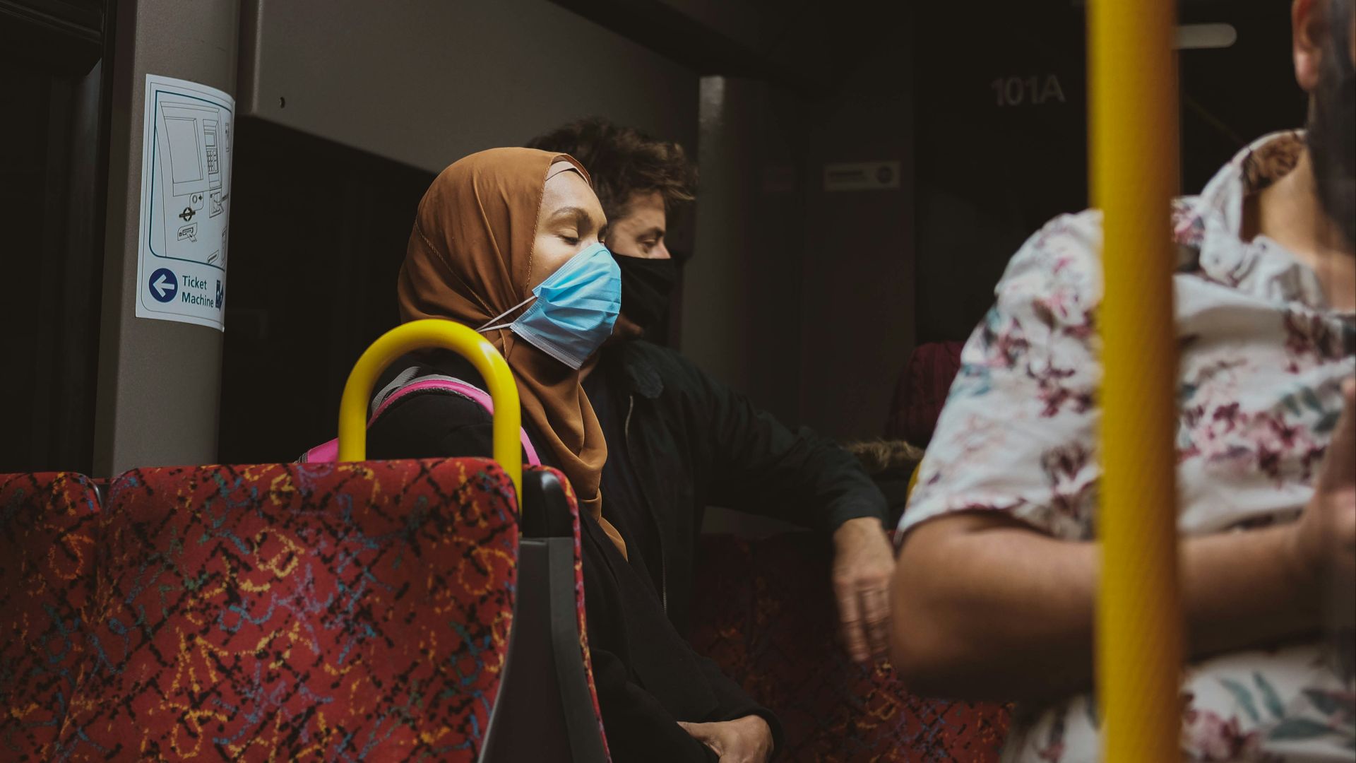 woman in black jacket sitting on chair
