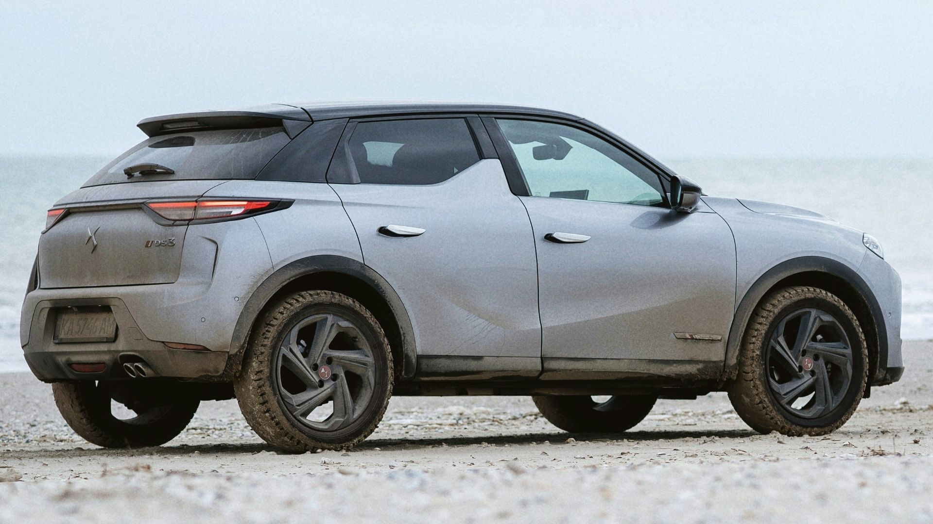 a car parked on a beach near the ocean