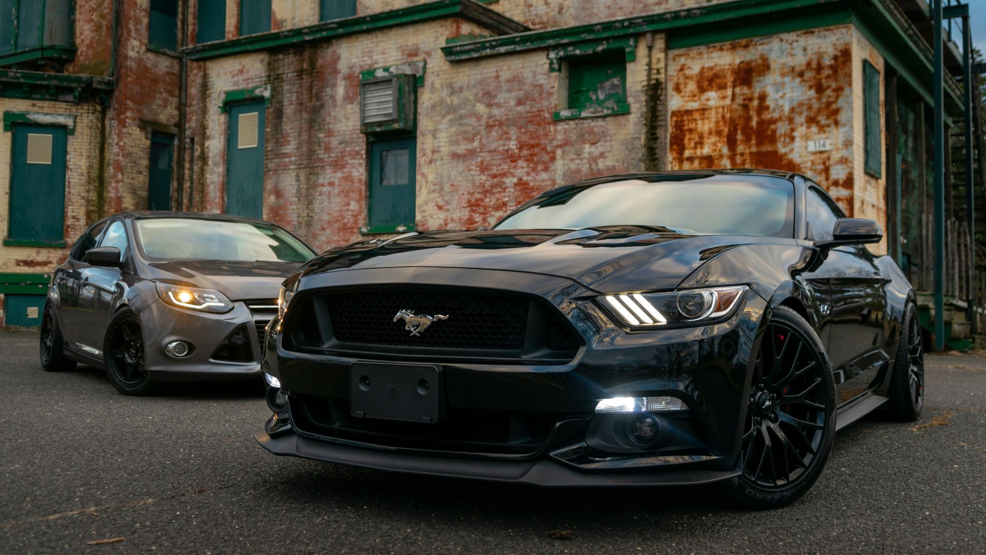 black bmw coupe parked on street during daytime