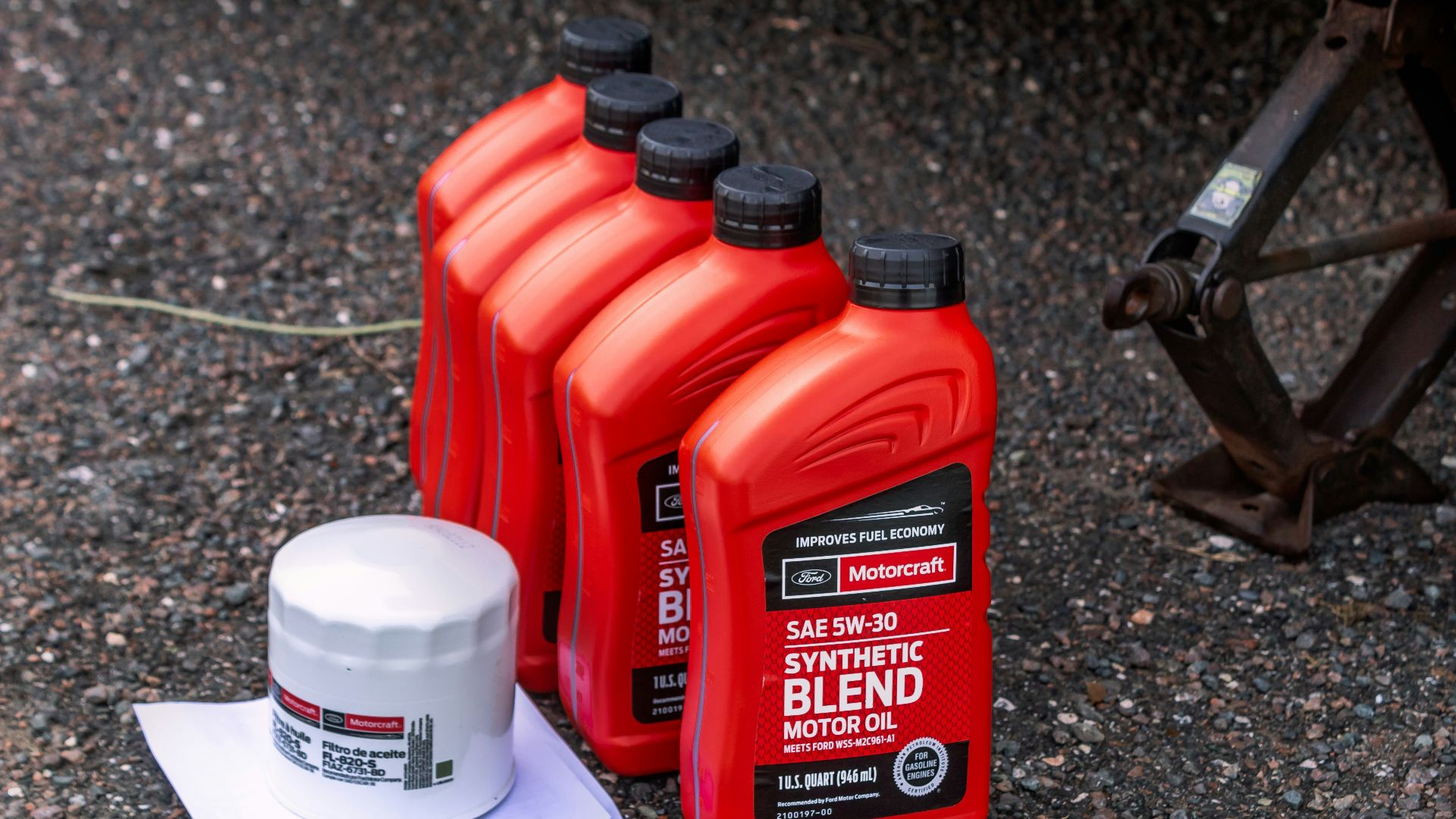 a couple of bottles of motor oil sitting on the ground