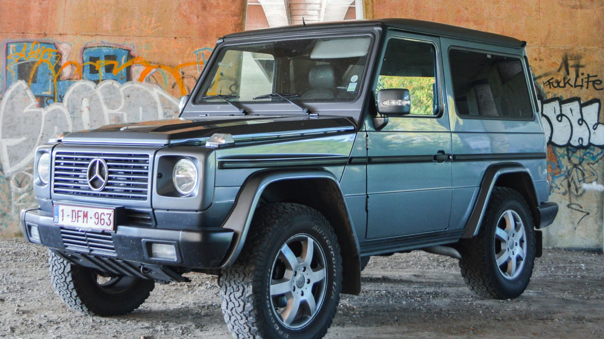 blue and black Mercedes-Benz SUV under bridge during daytime
