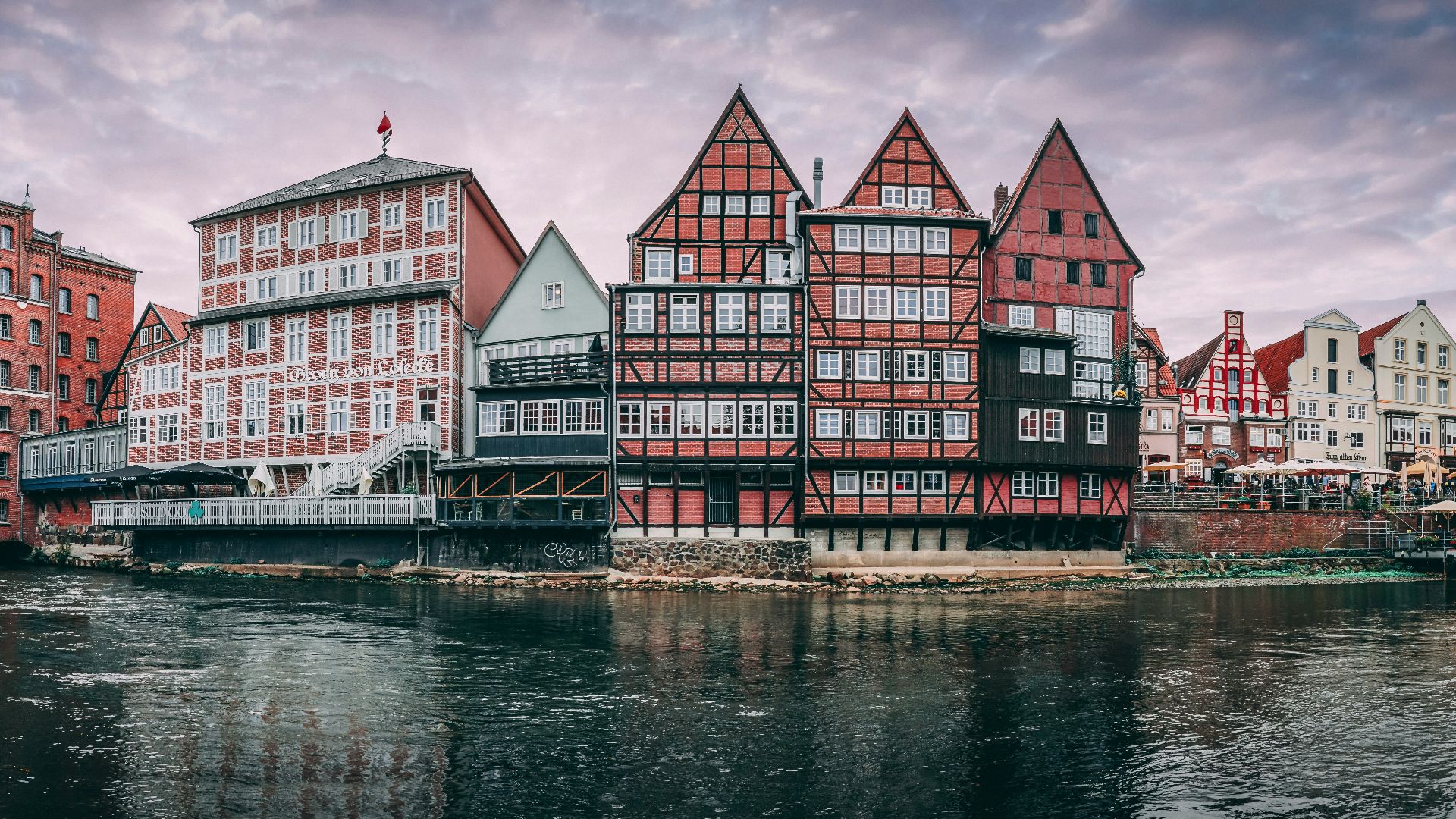 red and white concrete building beside body of water during daytime