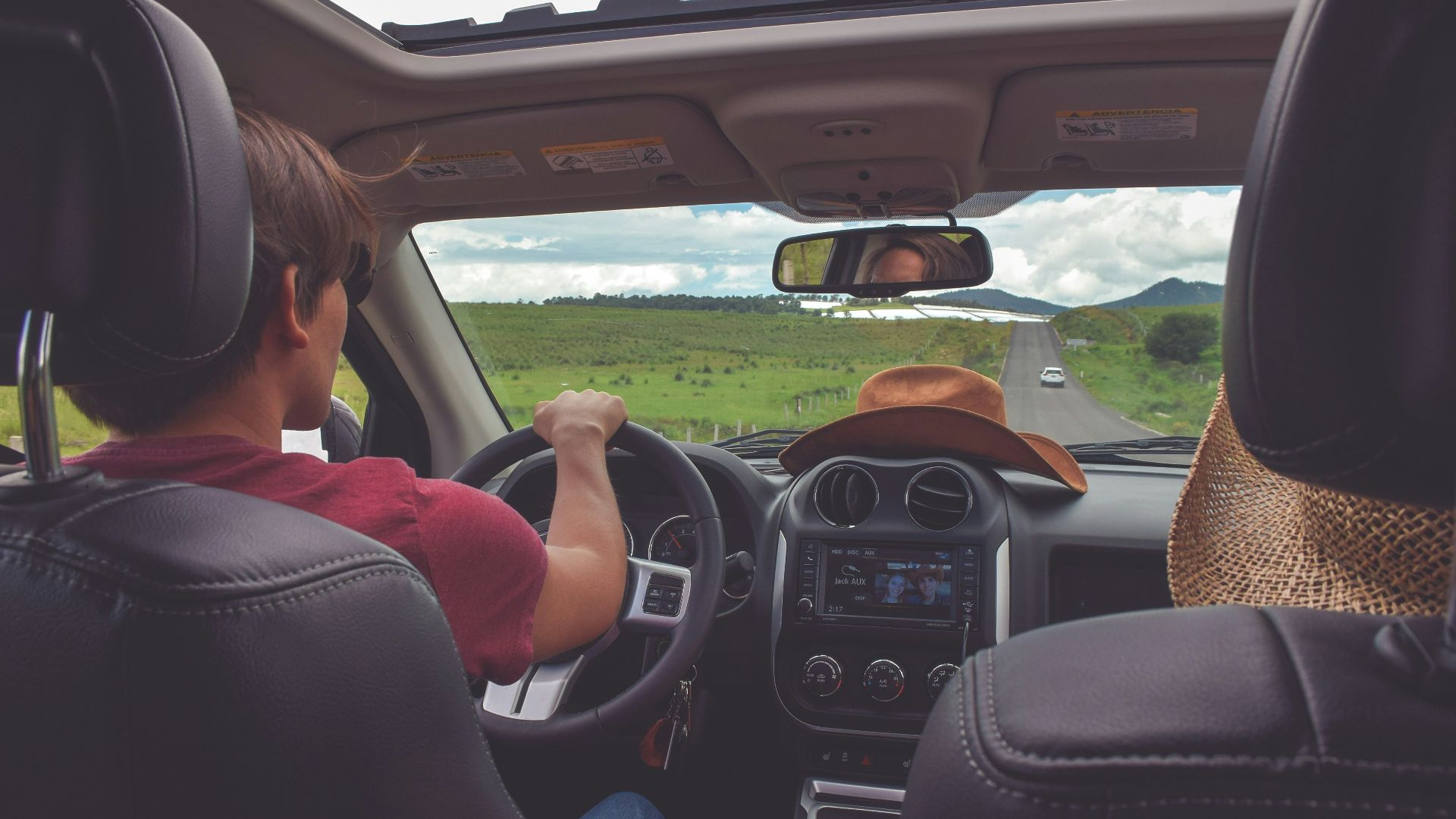 man driving straight on pathway during day time
