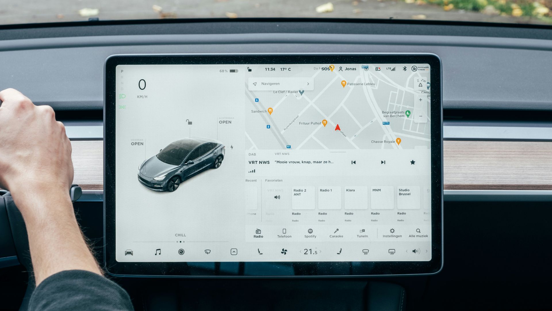 a person driving a car with a computer on the dashboard