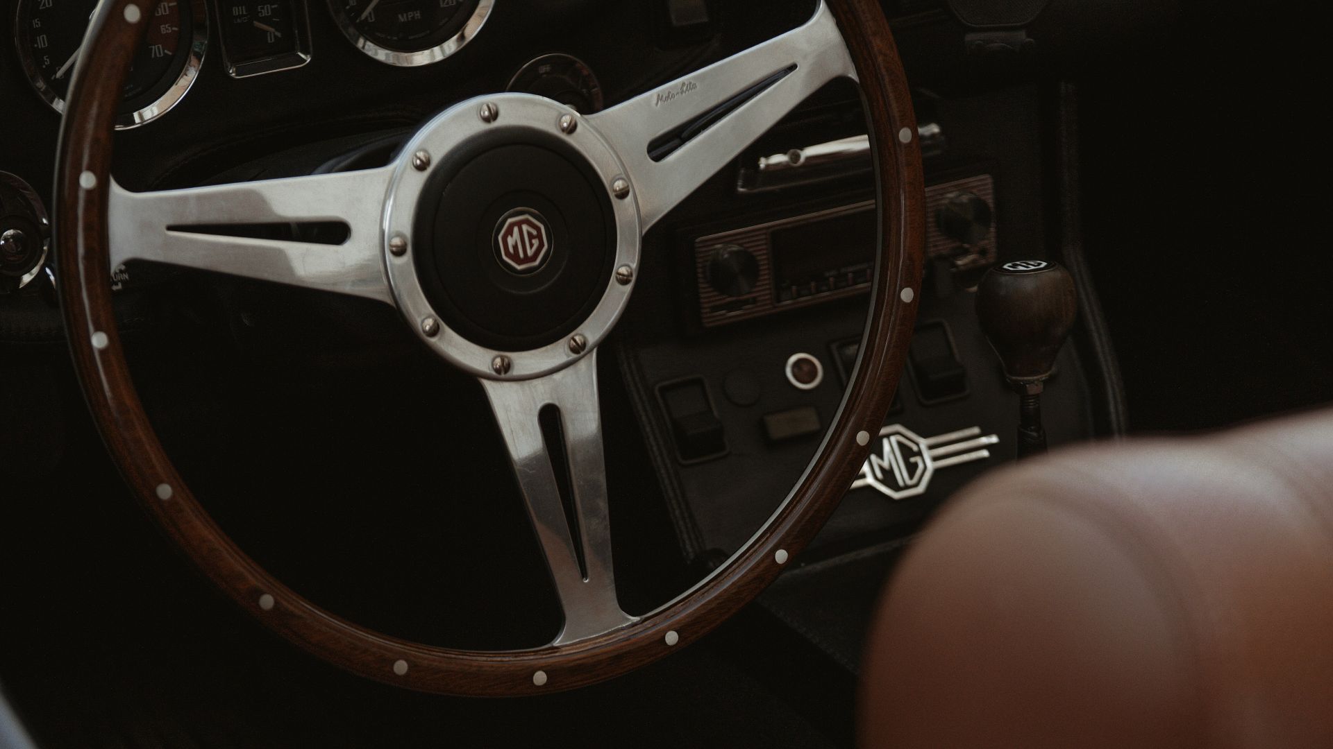 The interior of a car with a steering wheel and dashboard