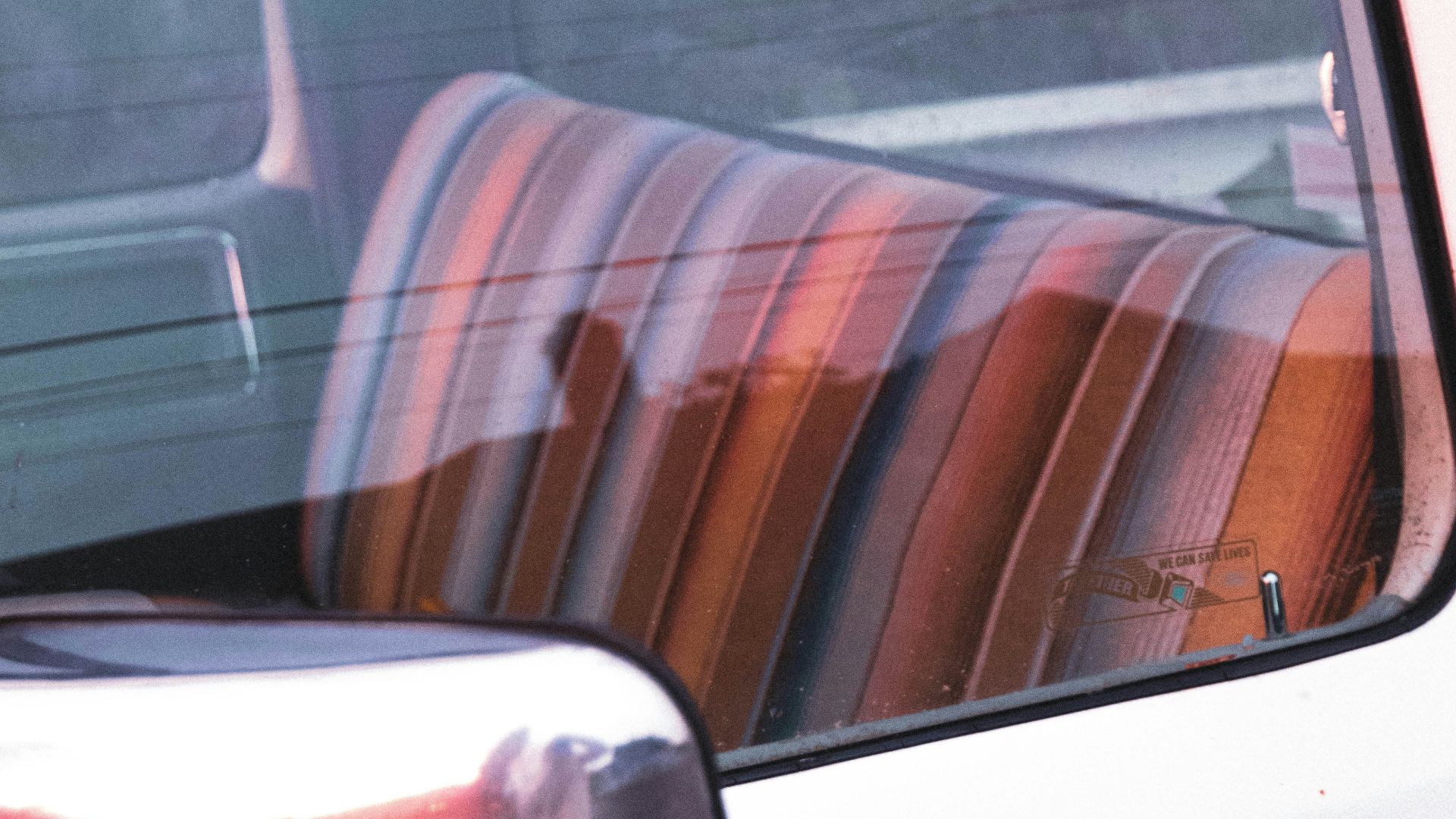 white car door with brown and white striped seat