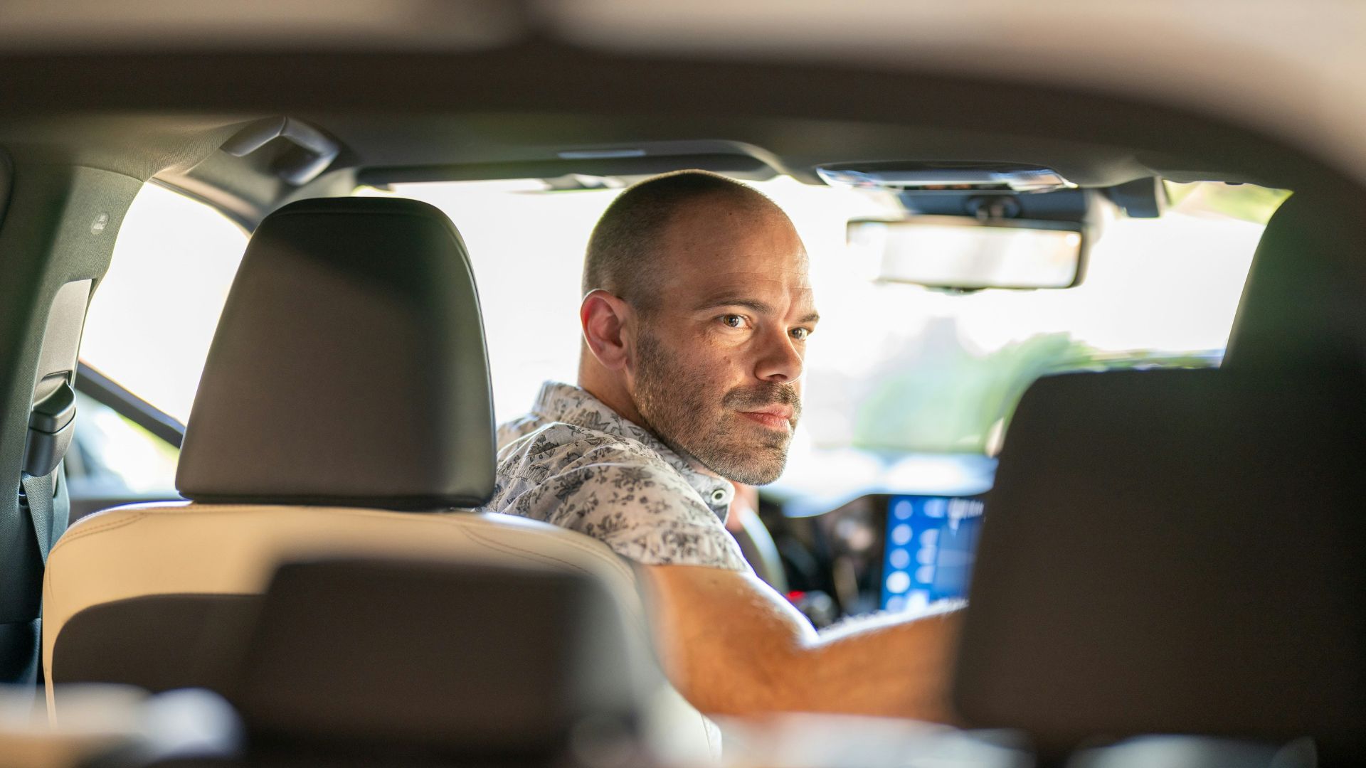 a man sitting in the passenger seat of a car