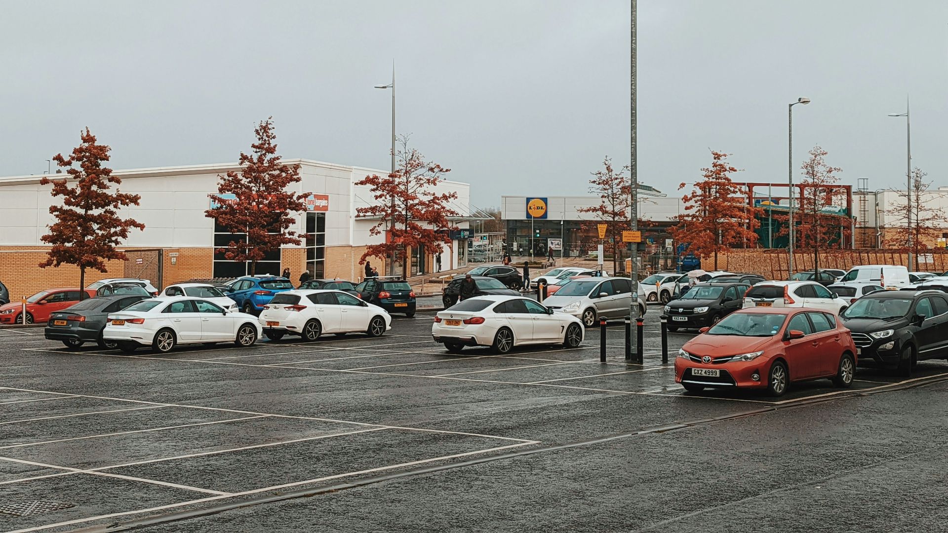 a parking lot filled with lots of parked cars