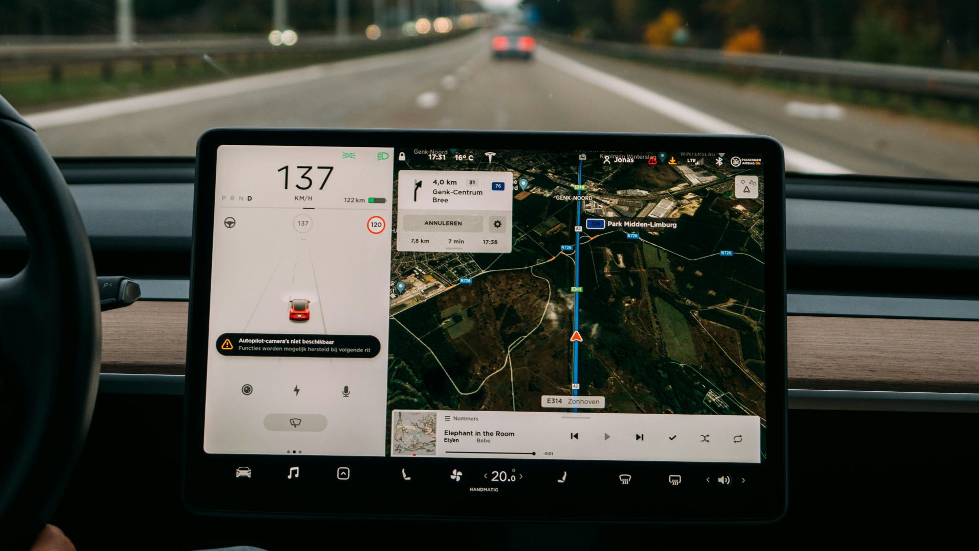 person holding white ipad inside car