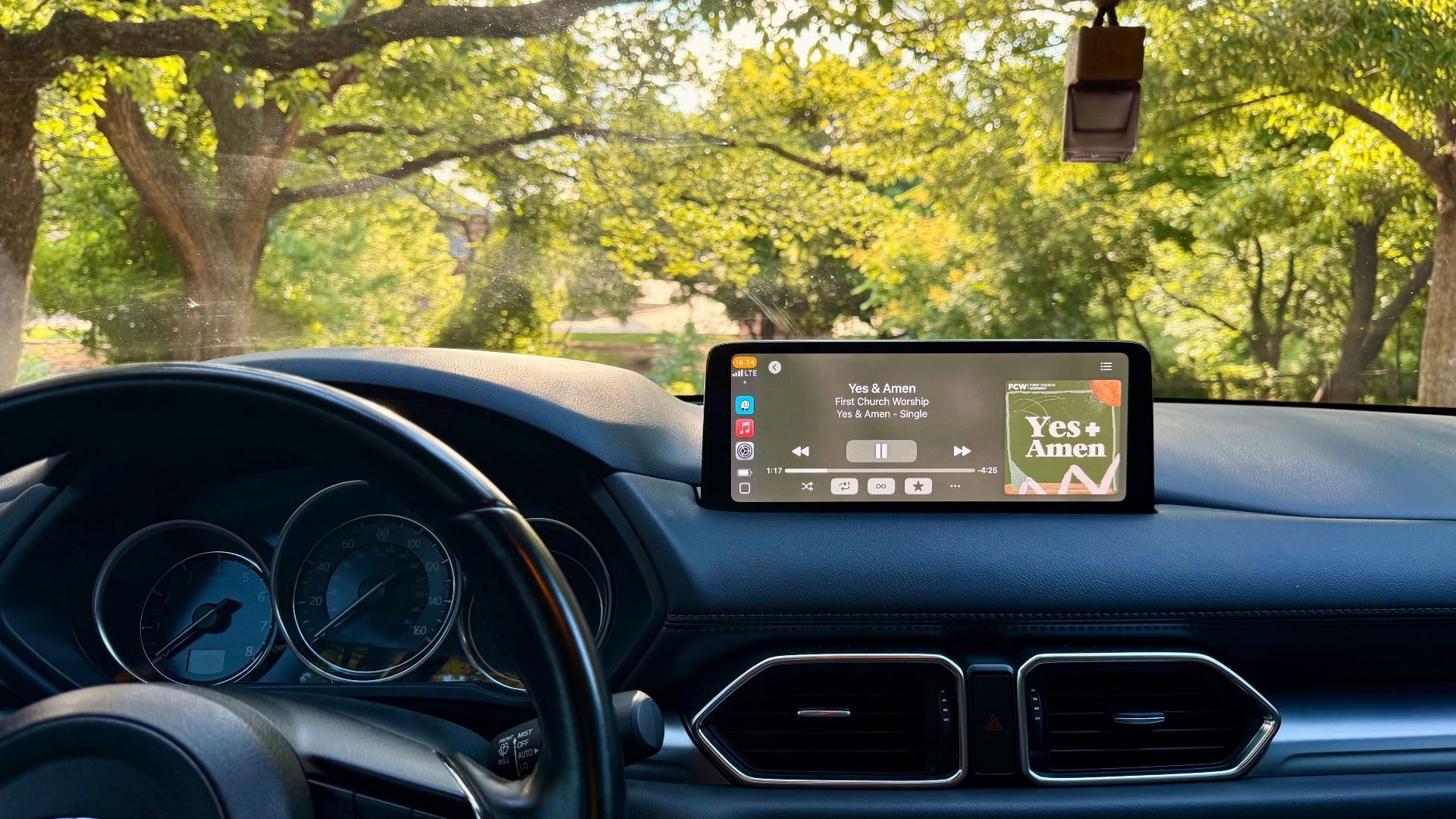 Car dashboard displays music while parked.