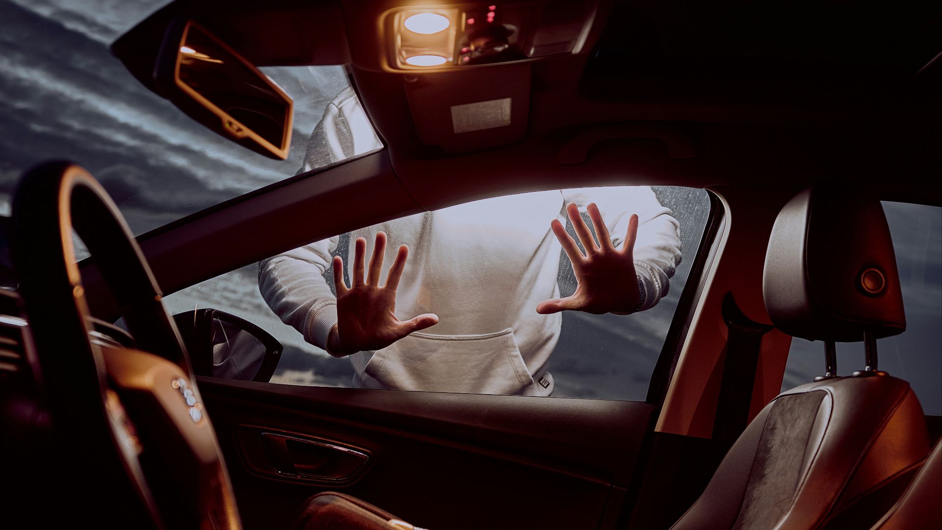 man in white long sleeve shirt driving car