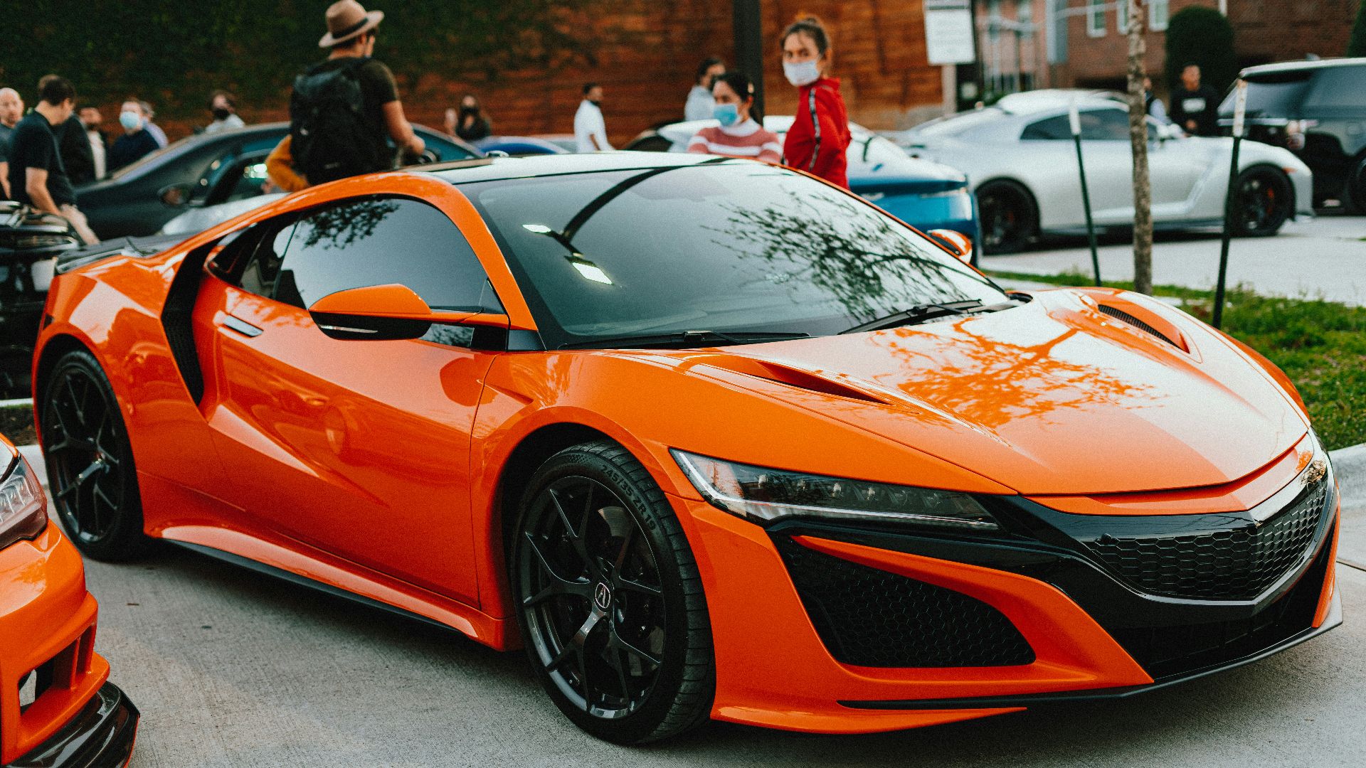 orange lamborghini aventador parked on gray pavement during daytime