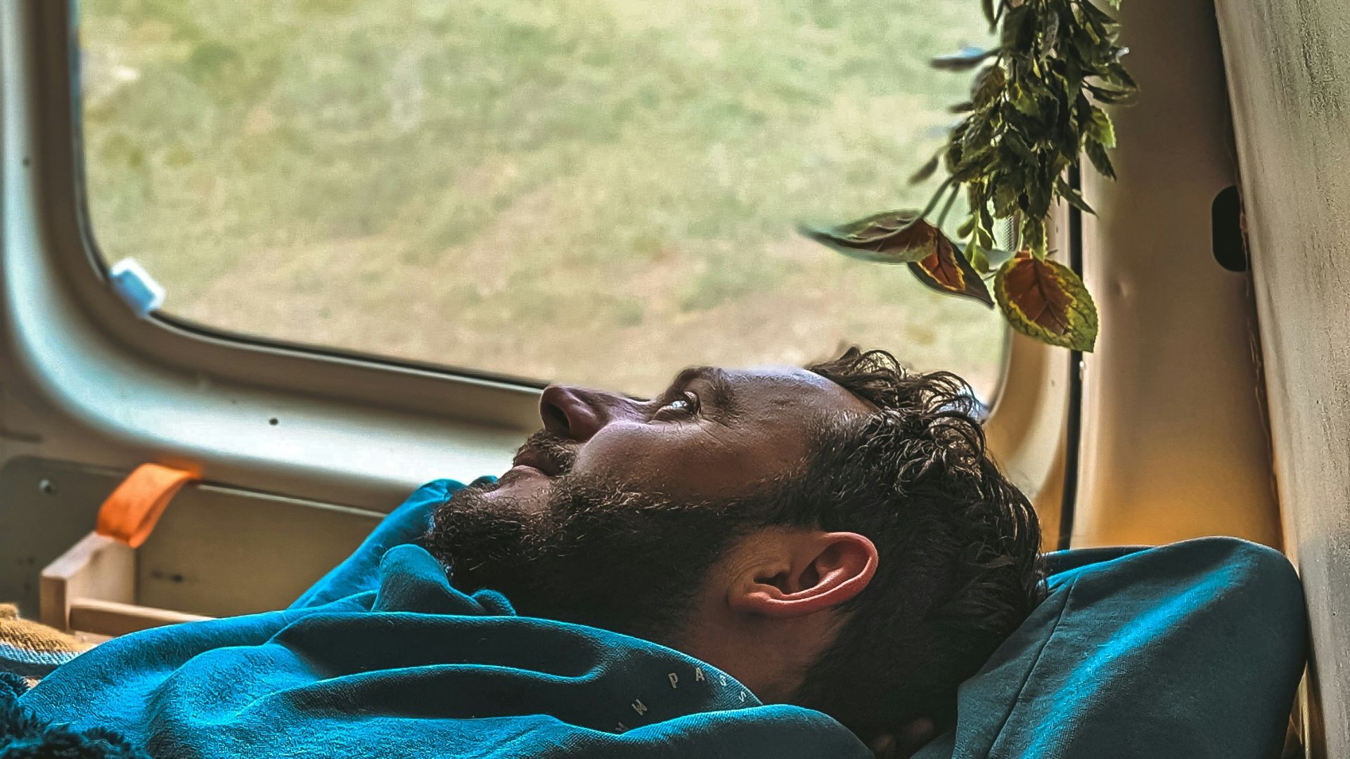 a man laying in a bed in a truck