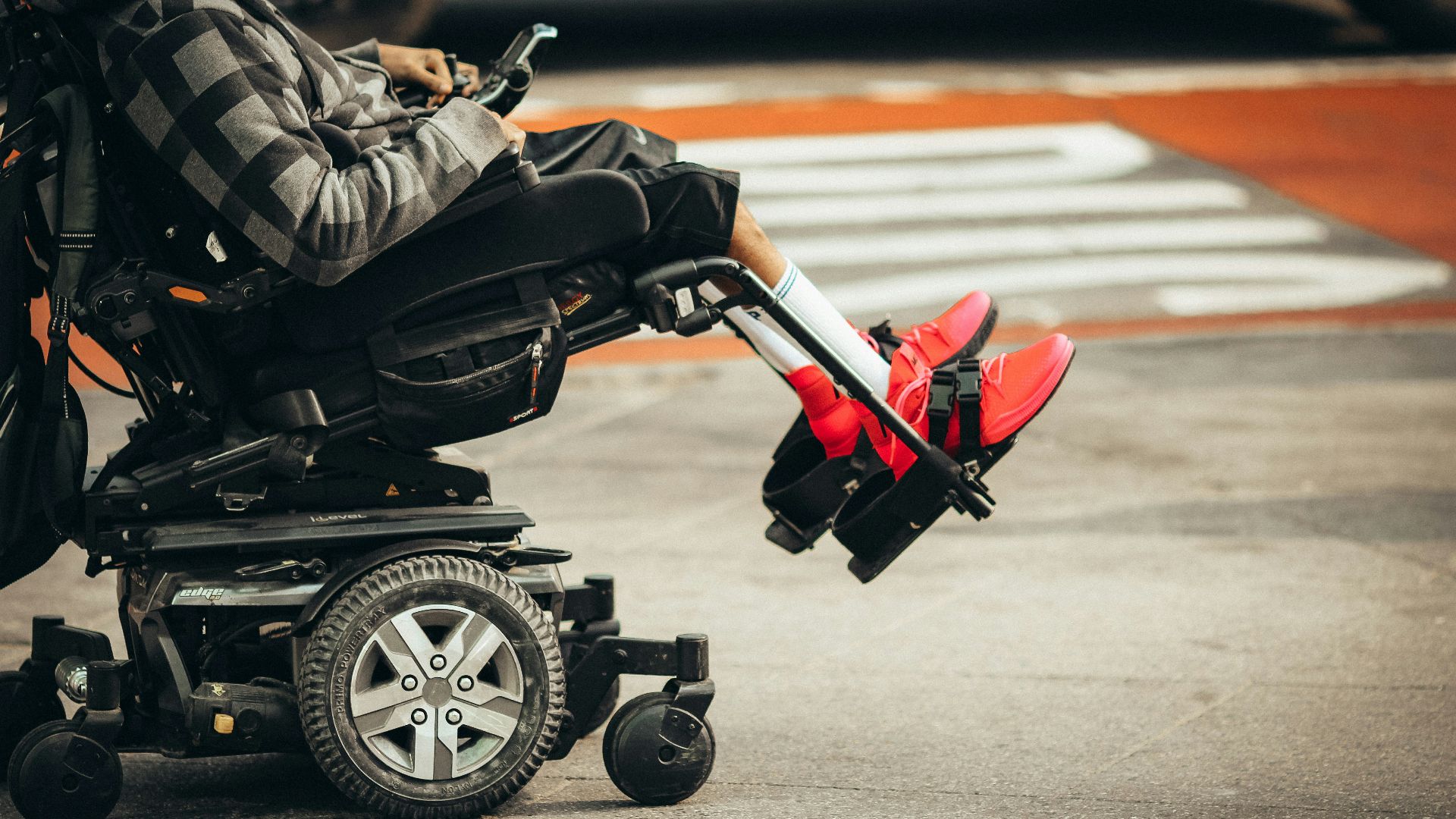 man in brown jacket and black pants riding black and red motorcycle