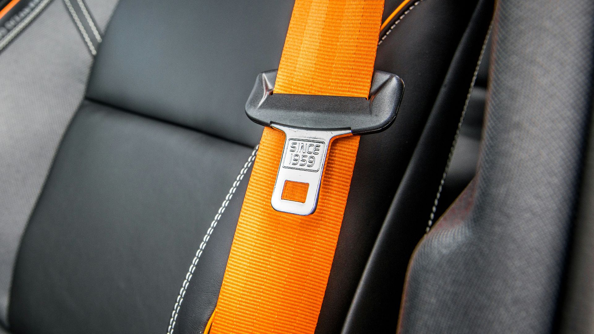 orange and white belt on black leather seat