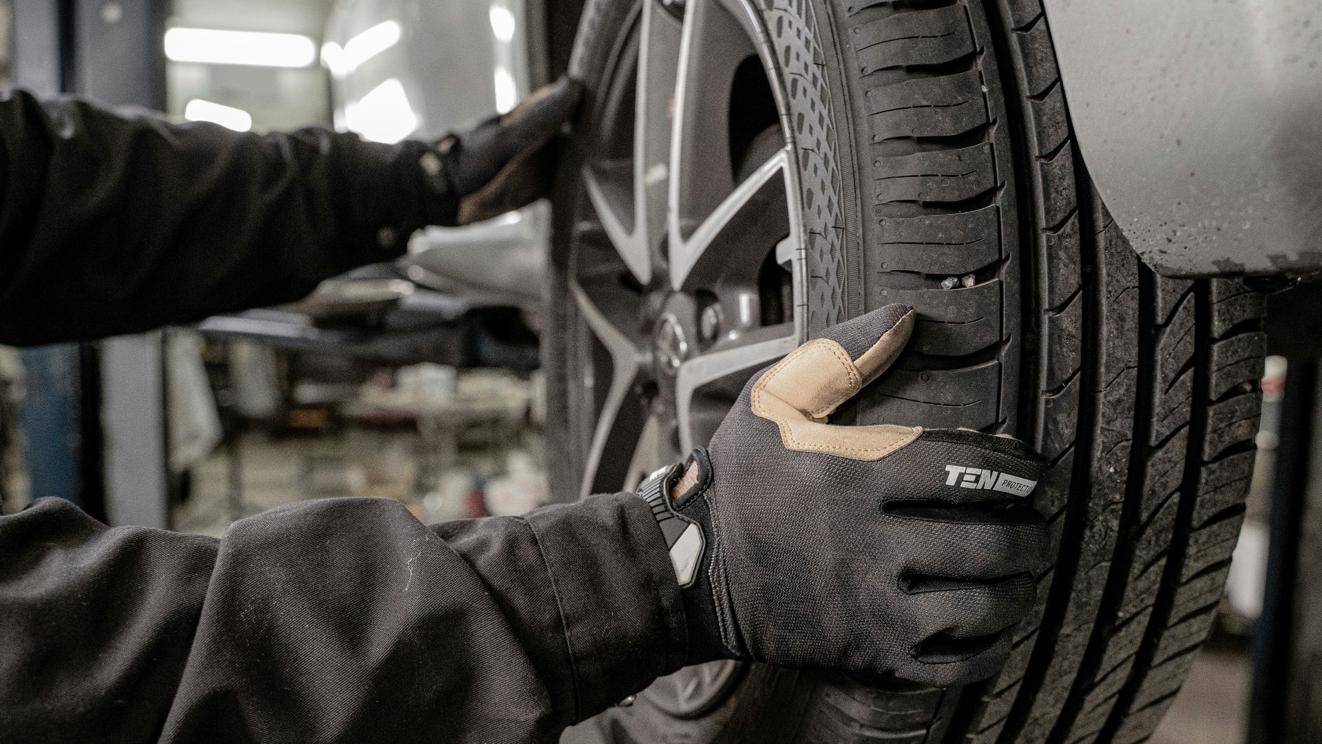 a man working on a tire in a garage
