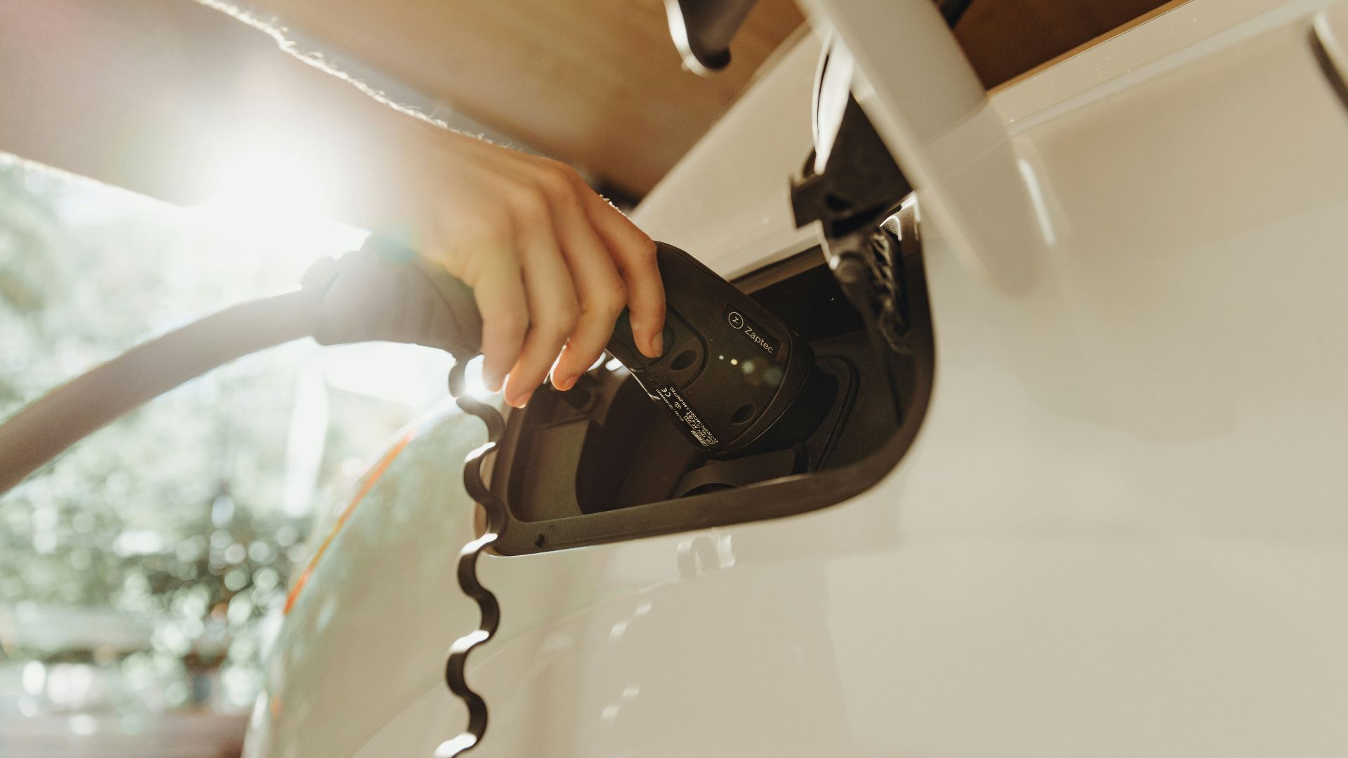 a person pumping gas into a car at a gas station