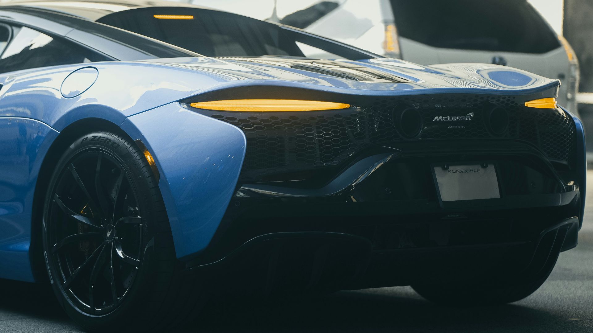 A sleek blue sports car parked outdoors.
