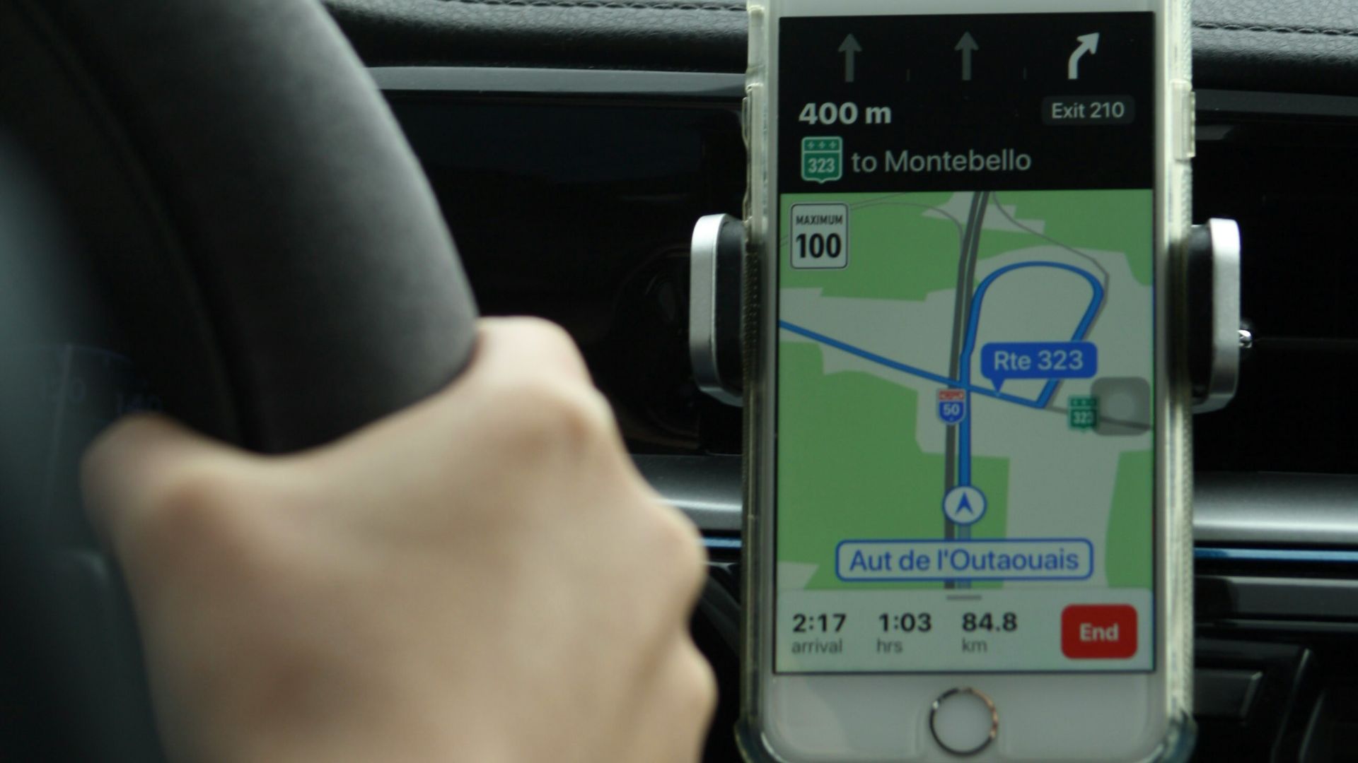 a person holding a cell phone while driving a car