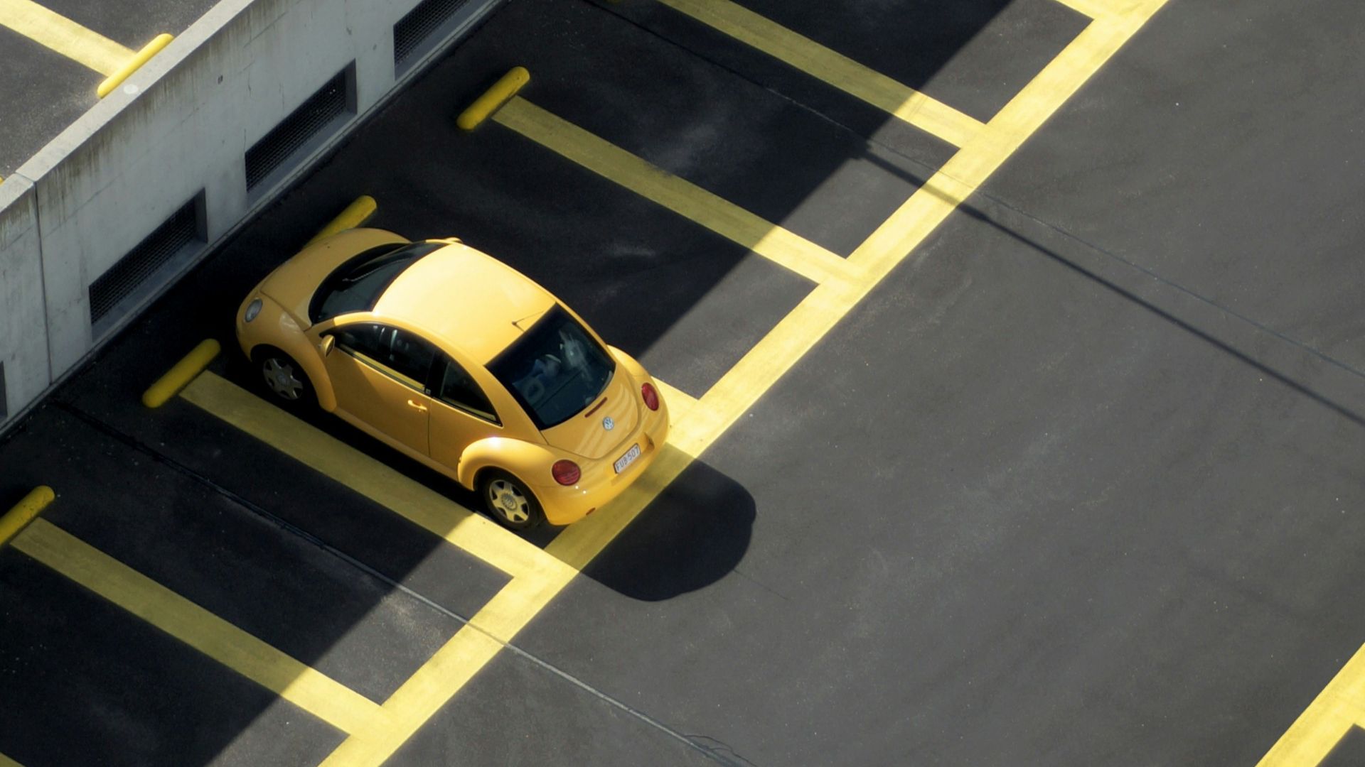yellow coupe on parking lot at daytime