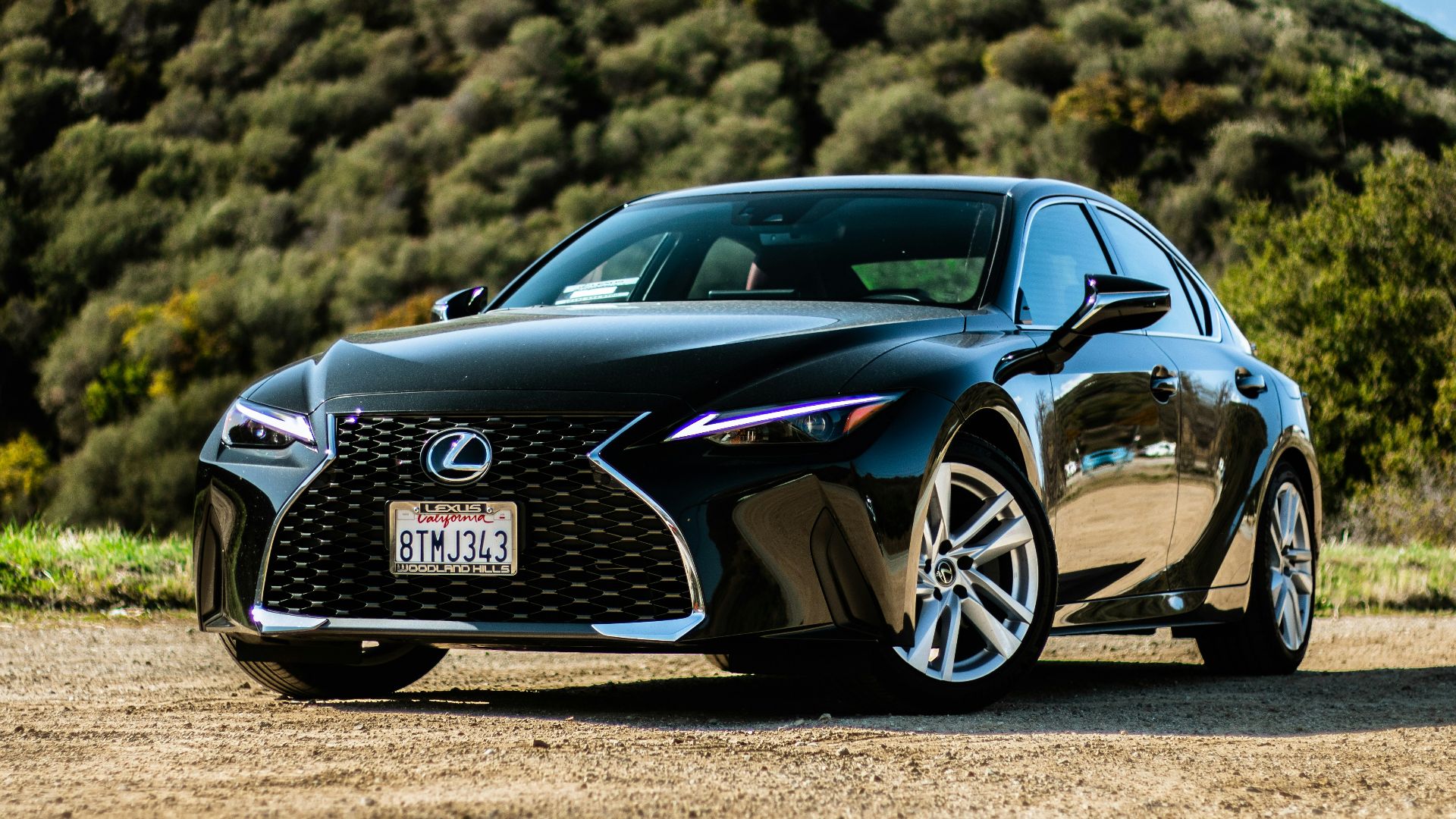 black porsche 911 on brown field during daytime