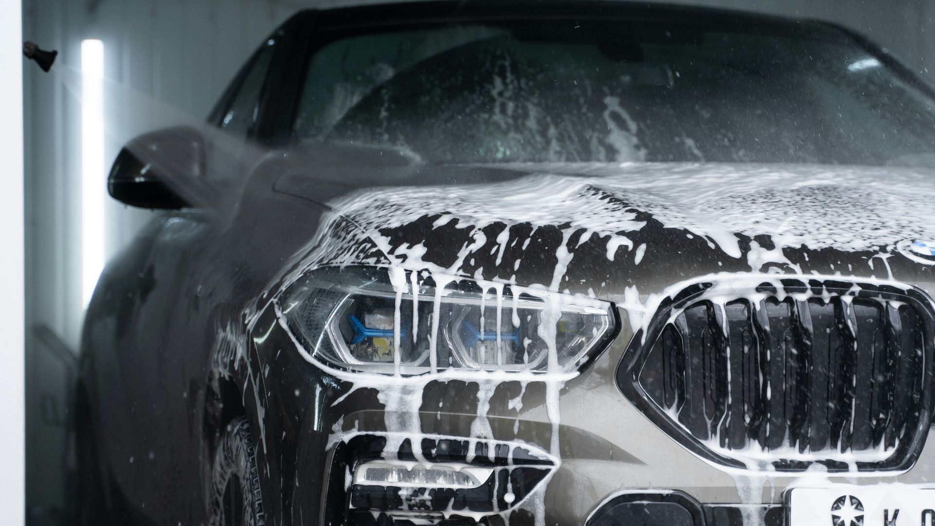 a car is covered in snow in a garage