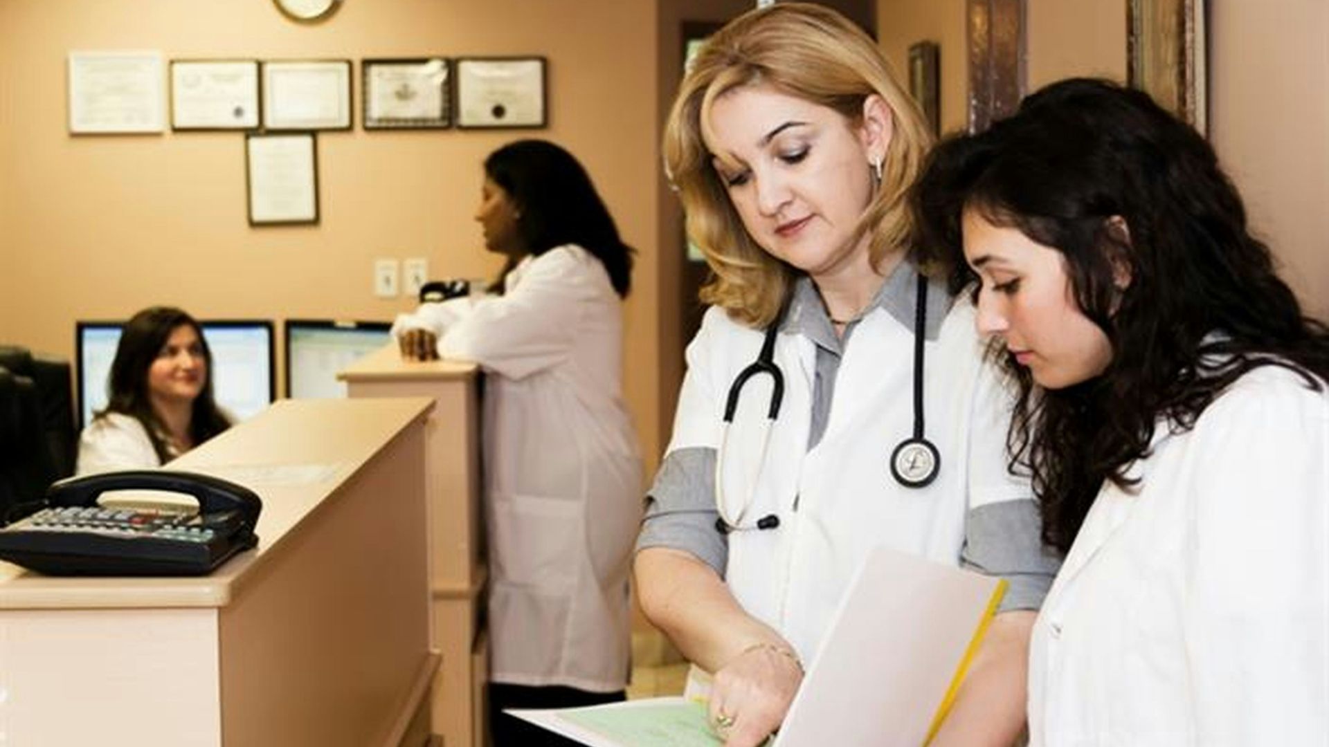 woman in white long sleeve shirt holding white printer paper