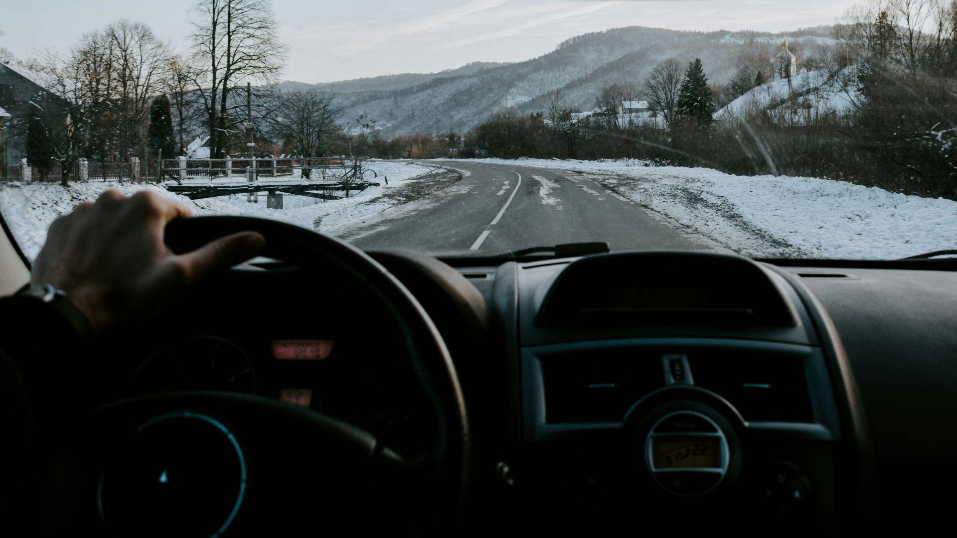 person holding steering wheel
