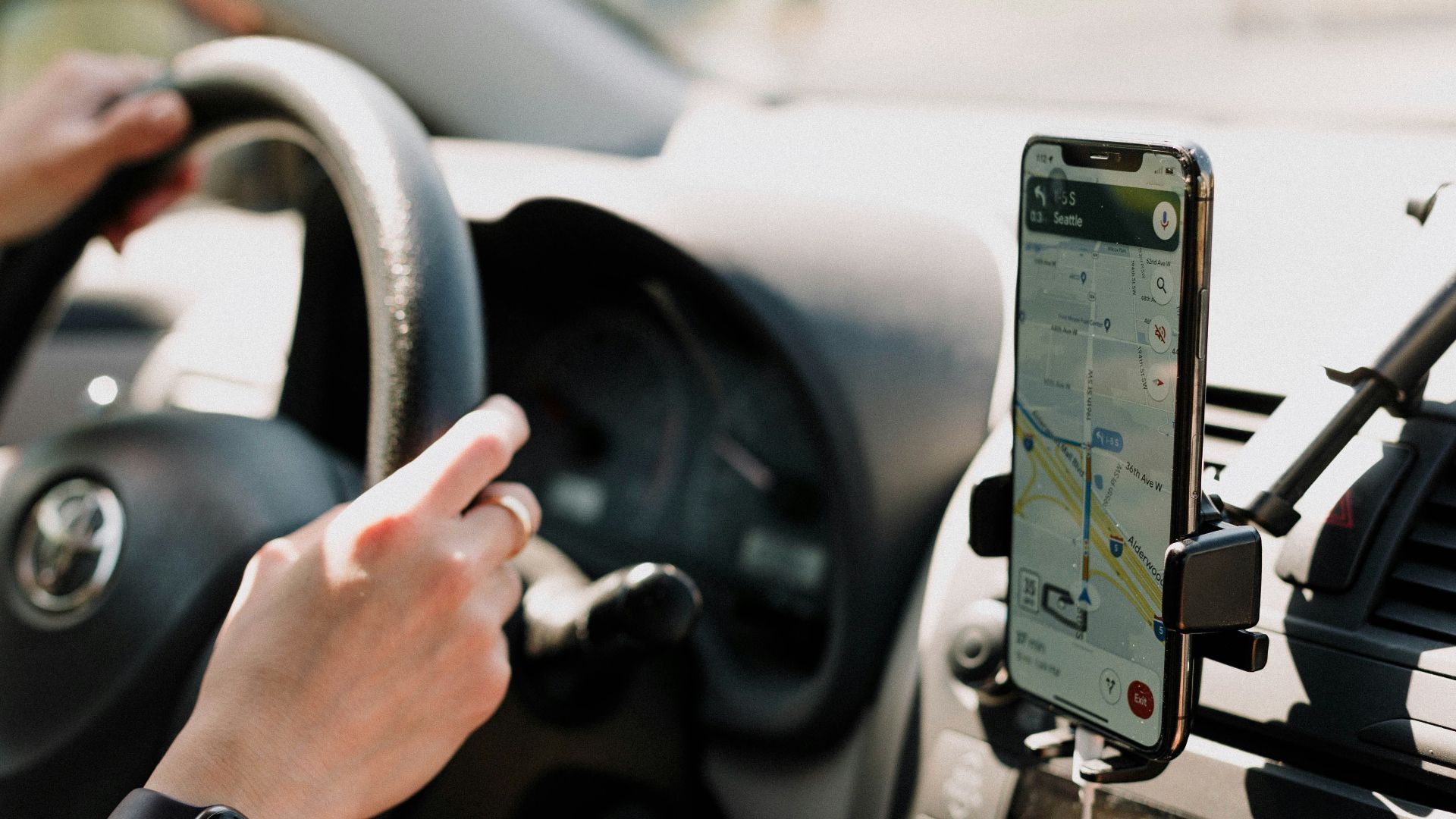 a person using a cell phone while driving a car