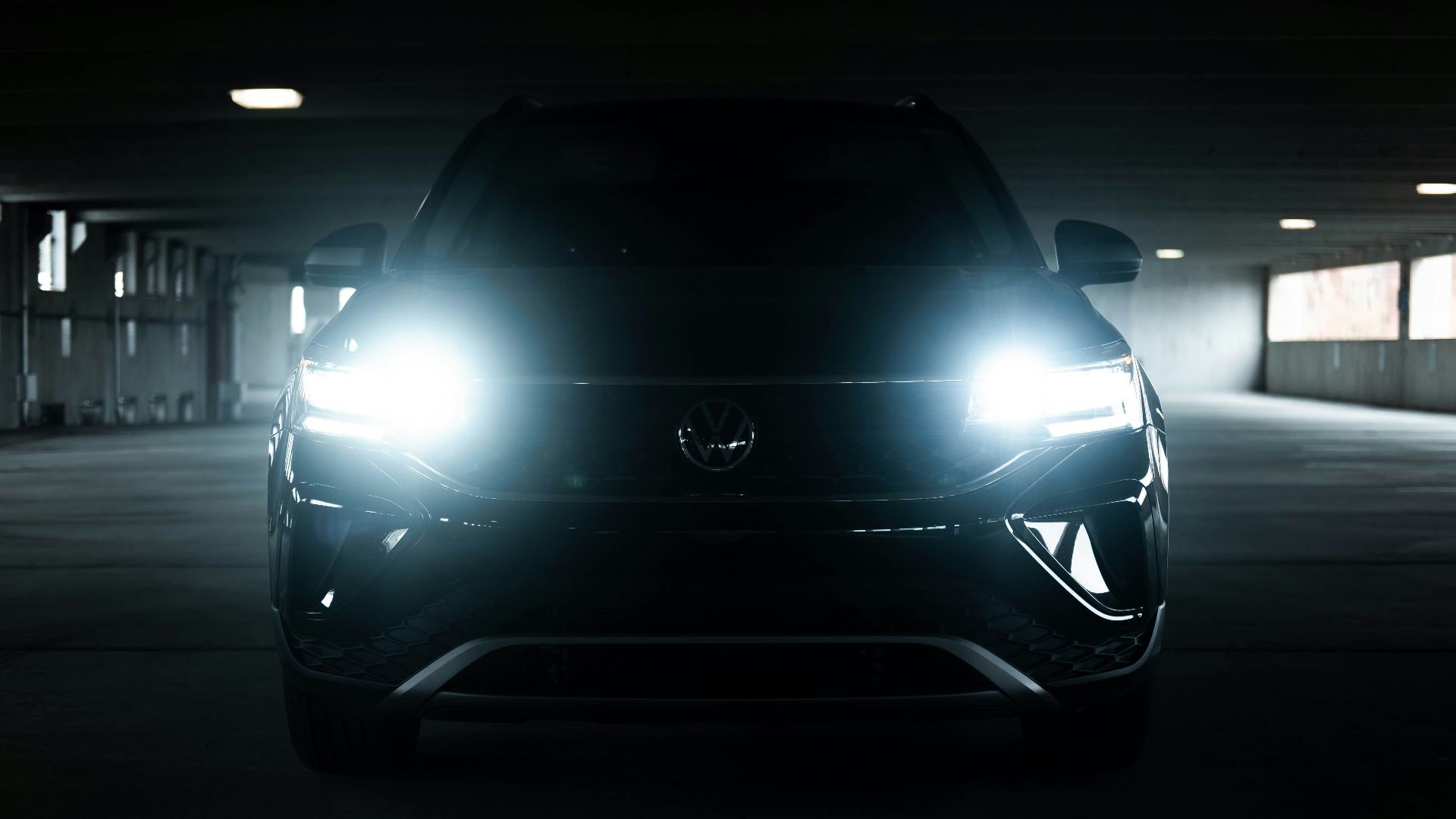 the front of a black car in a parking garage