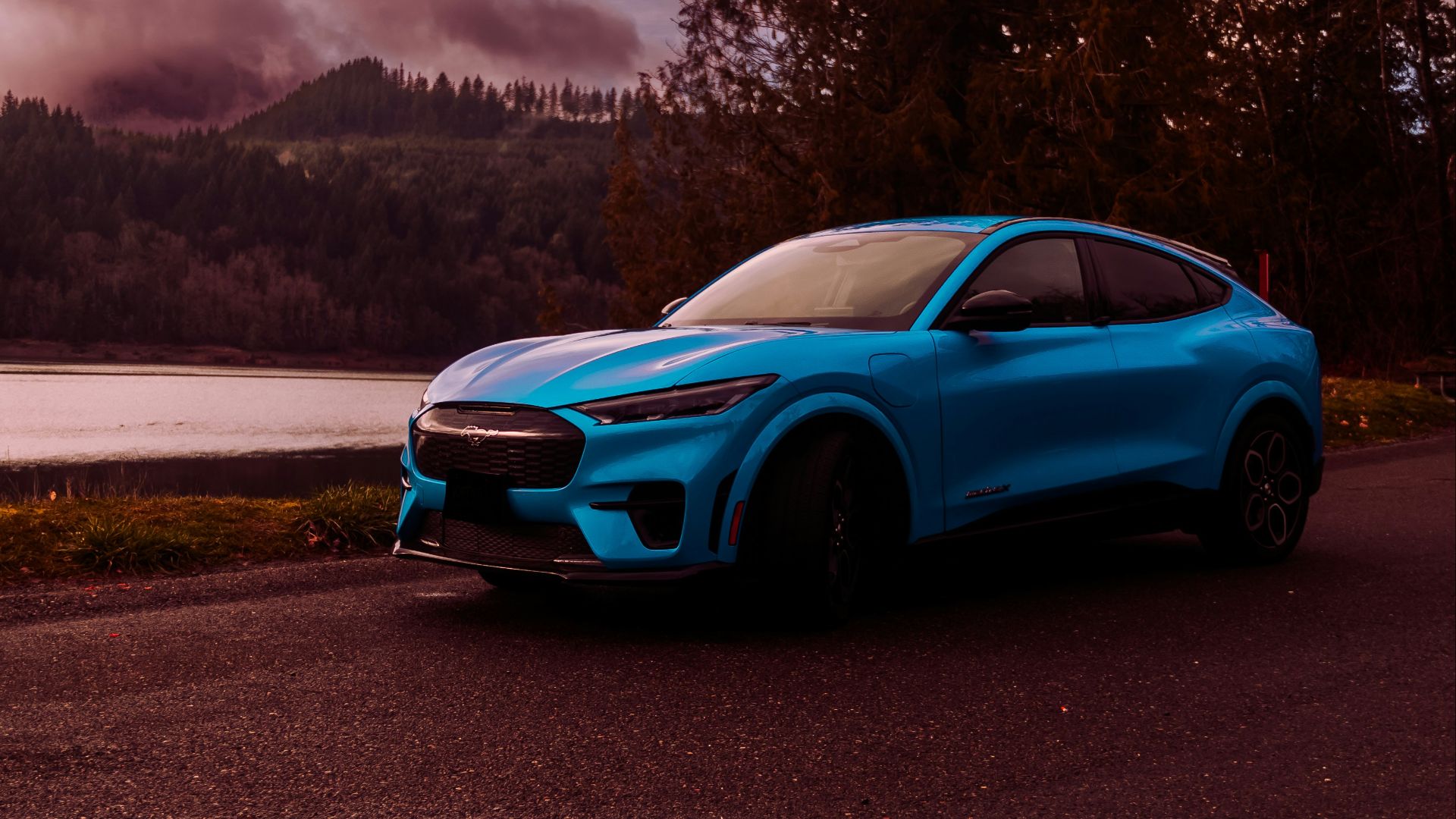 a blue sports car parked on the side of a road