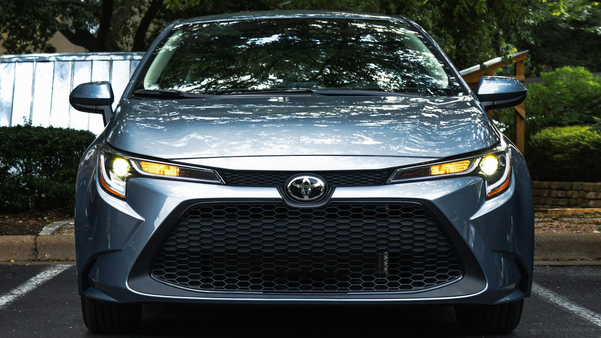 black mercedes benz car parked near green trees during daytime
